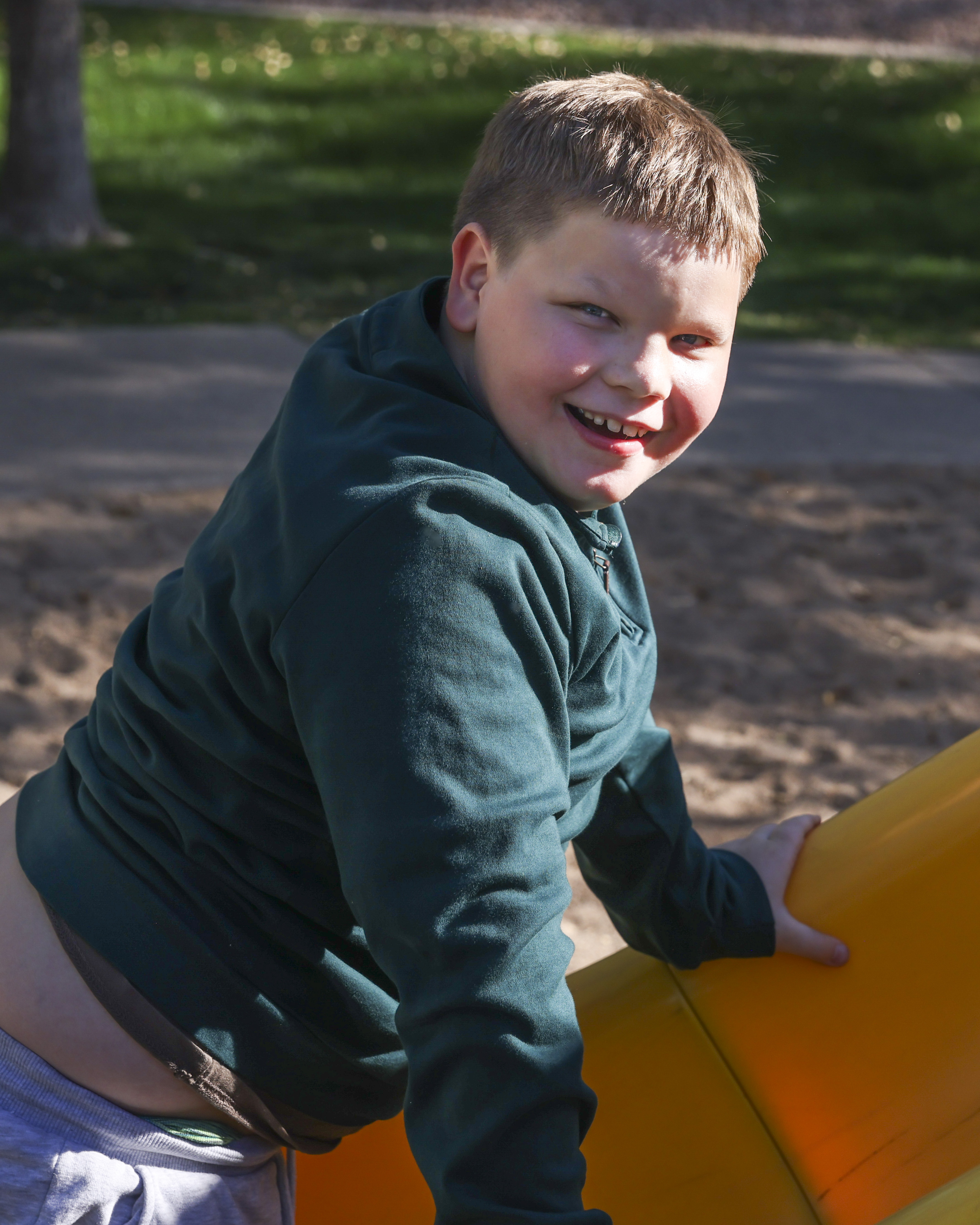 Allen leaning on slide smiling