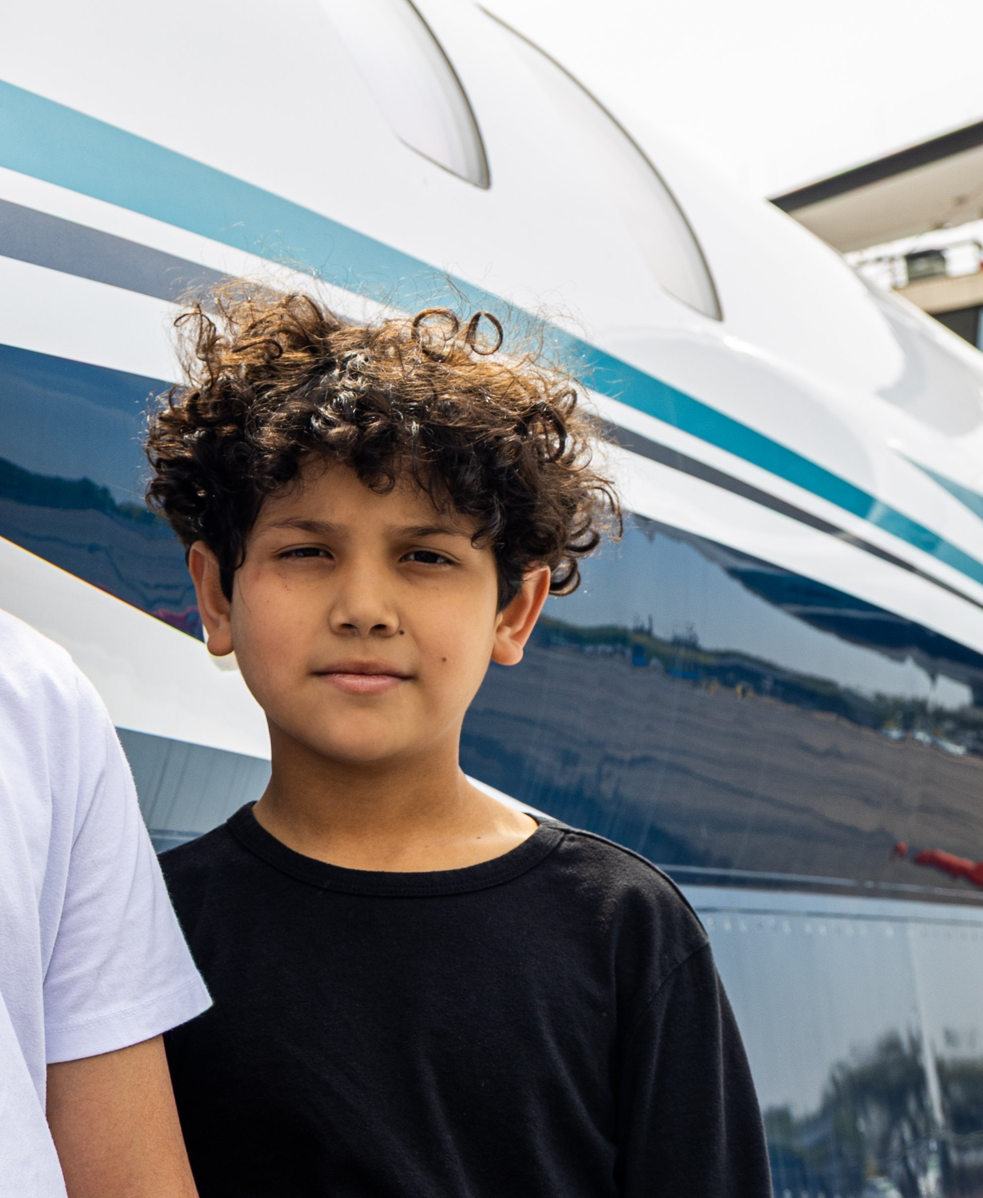 Adan standing next to jet