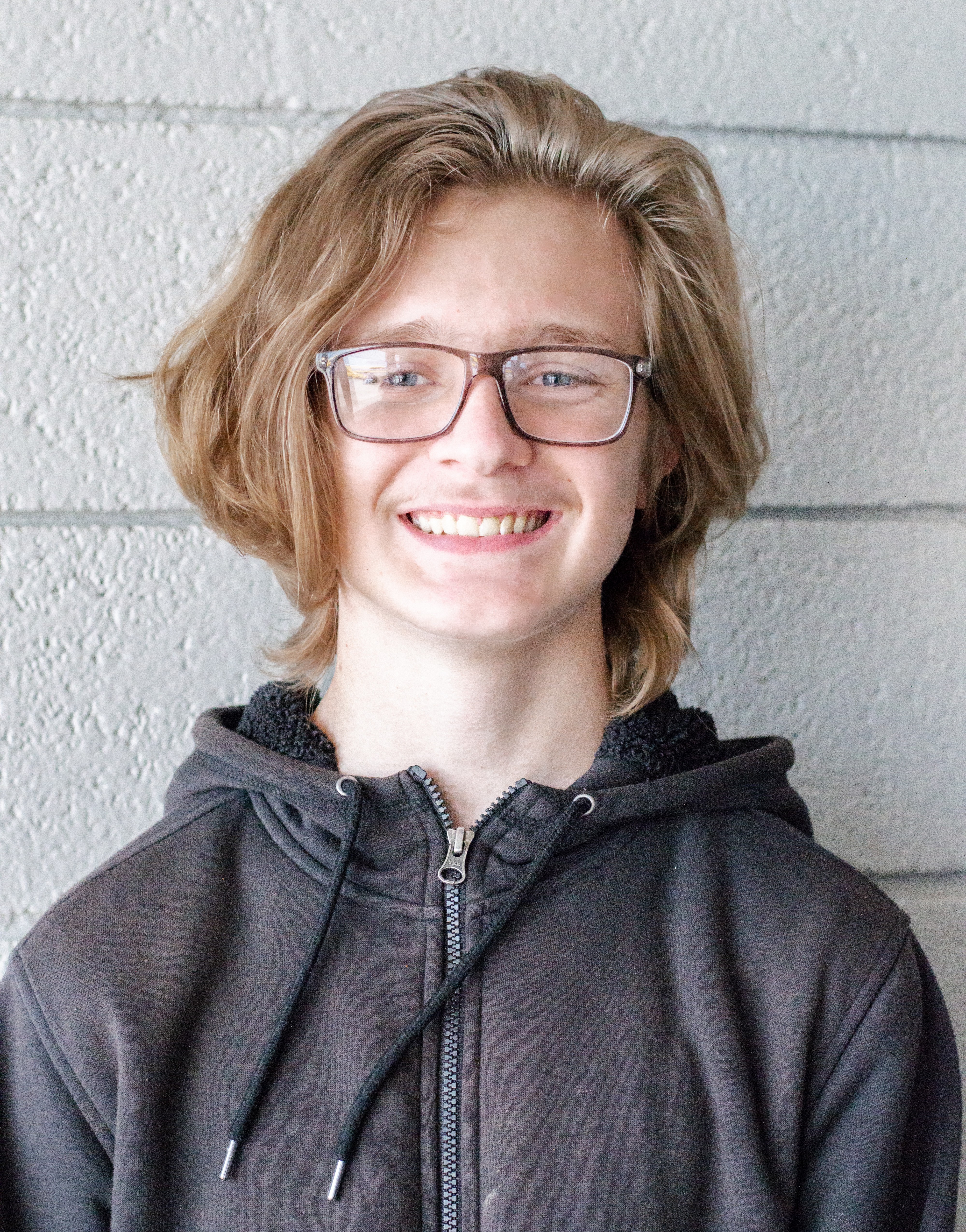 Aiden smiling with white background