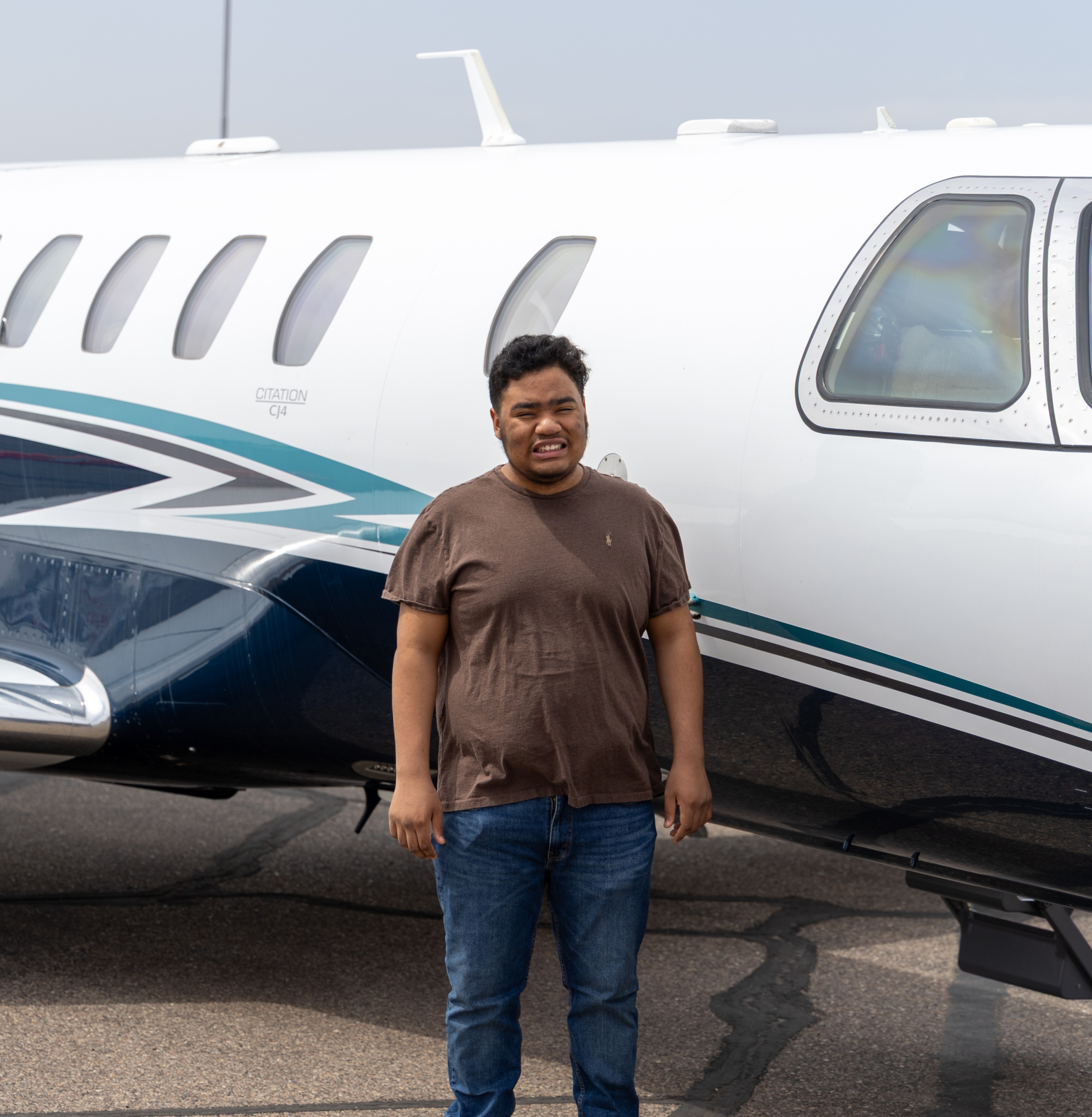 Andre standing next to jet