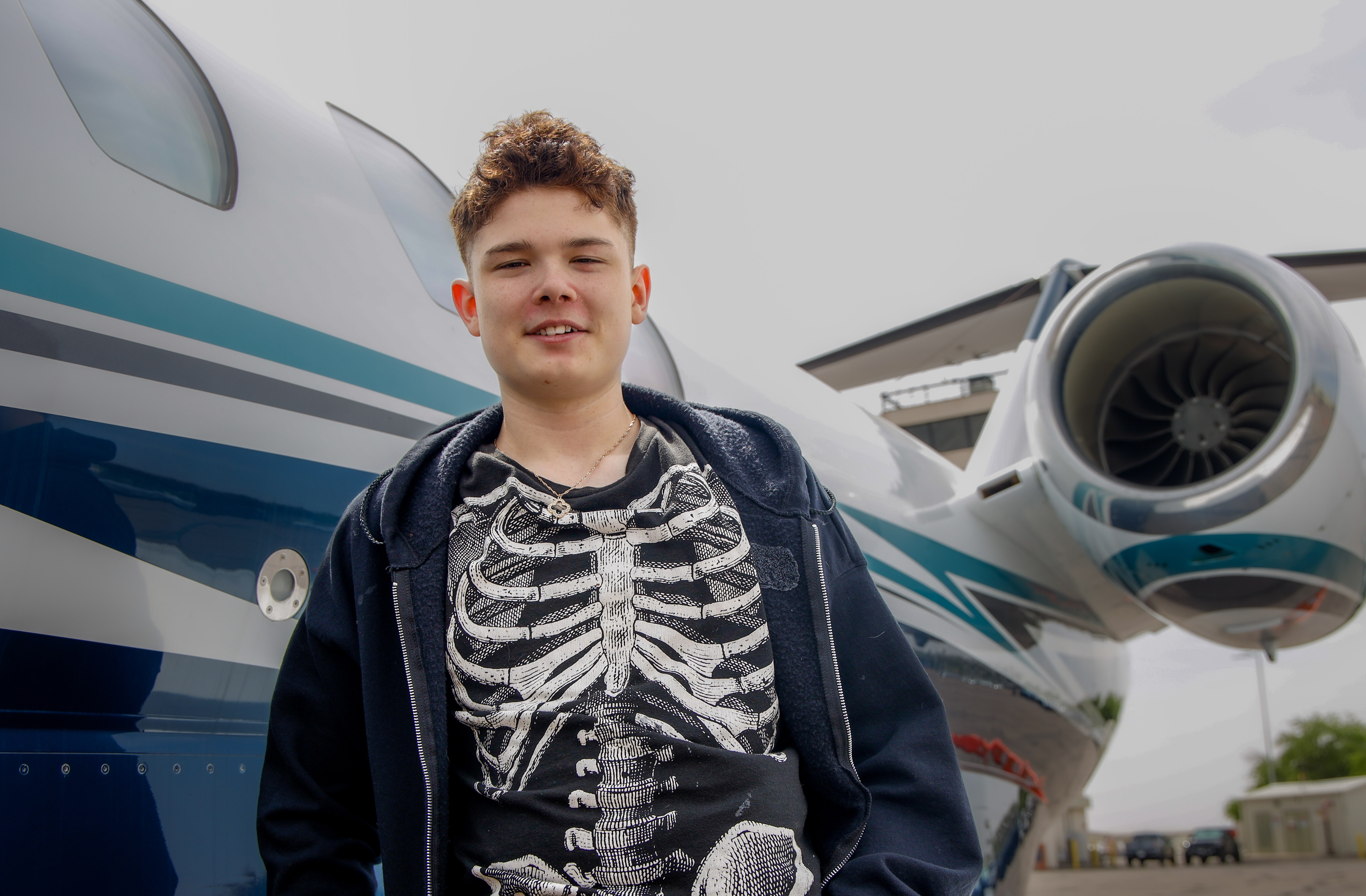 Diesel smiling next to plane