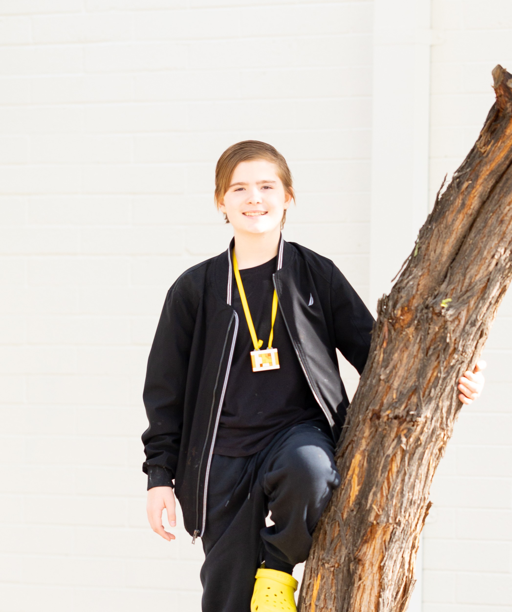 Ethan leaning on a tree