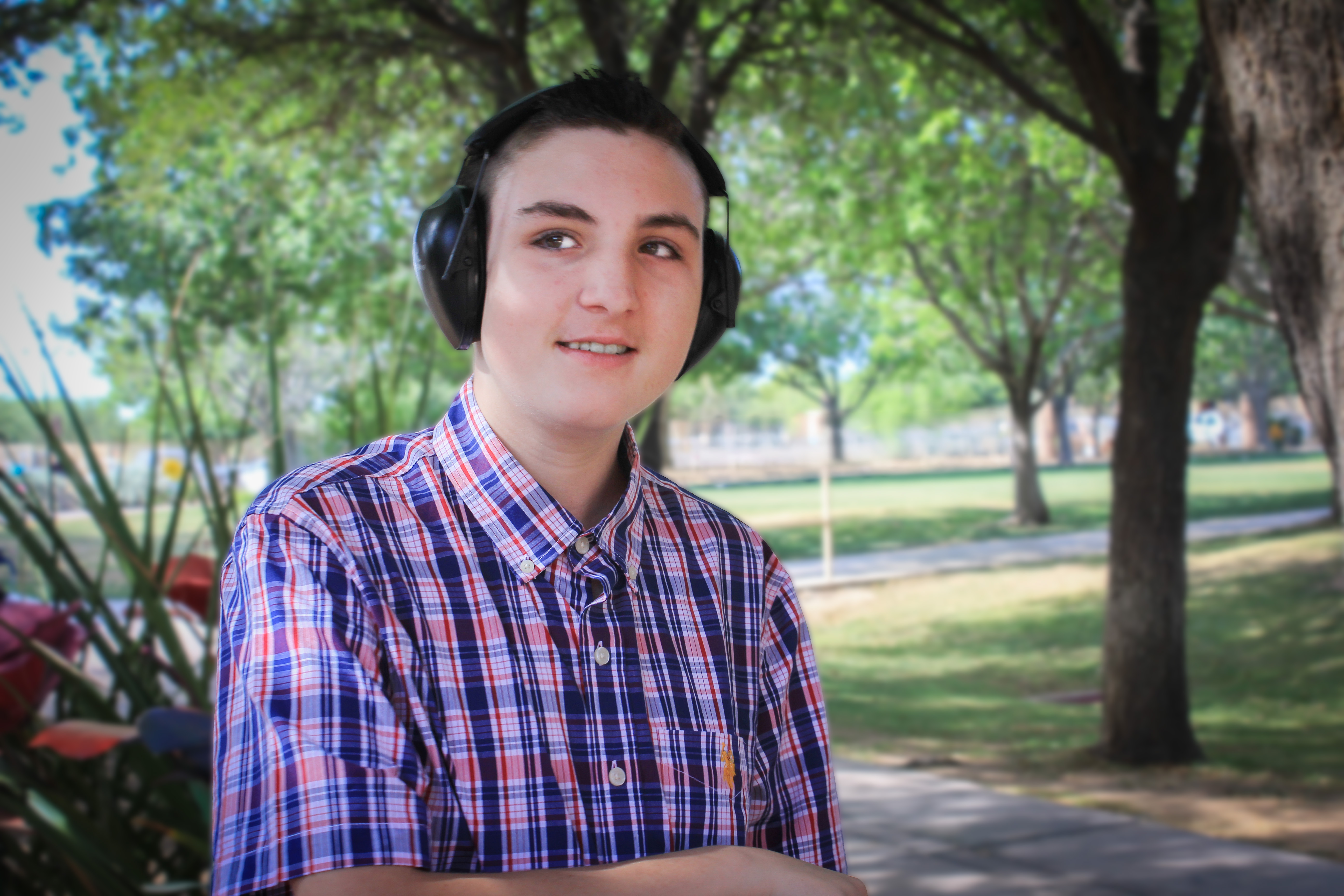 Gage smiling with hands crossed in front of him.