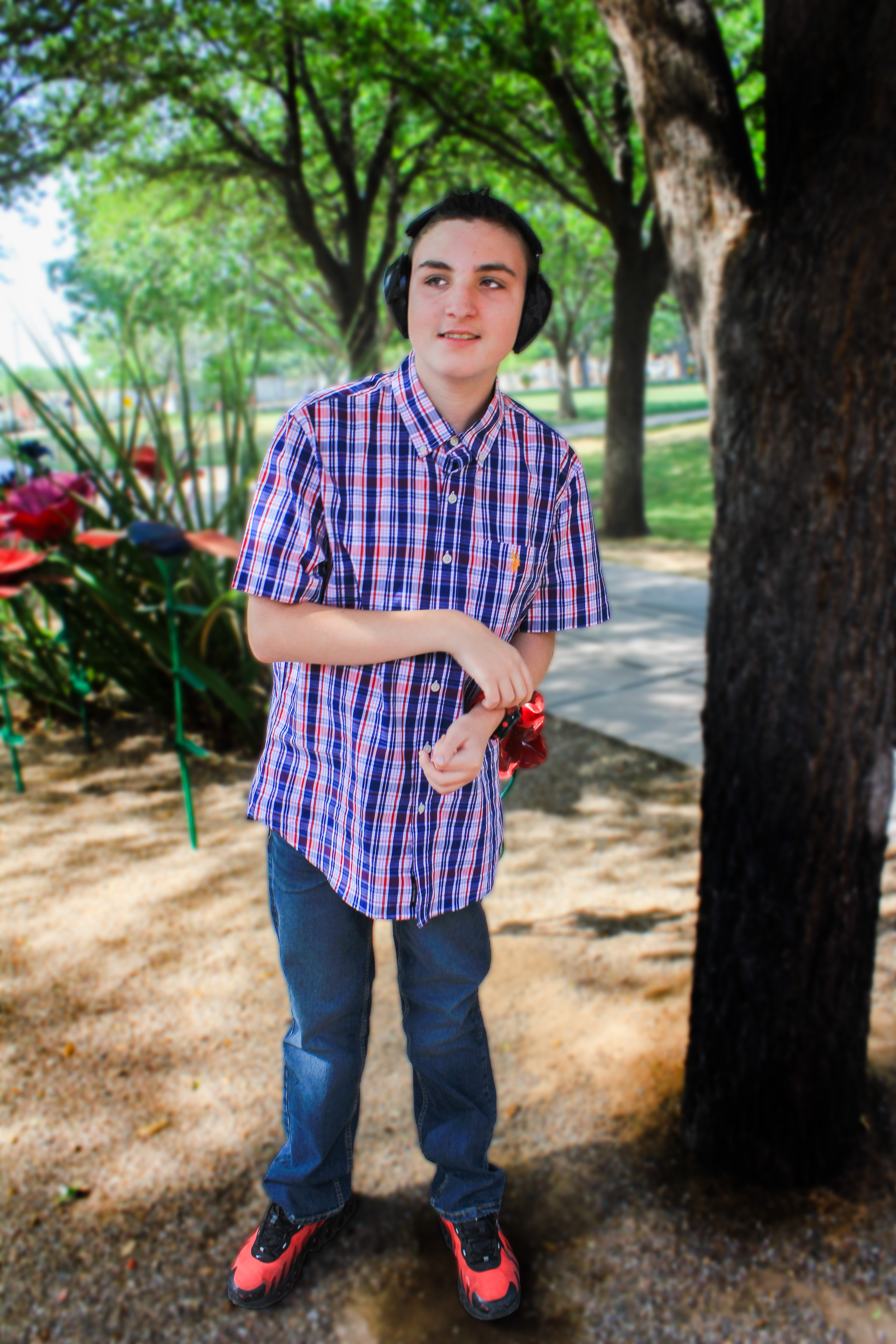 Gage standing by tree