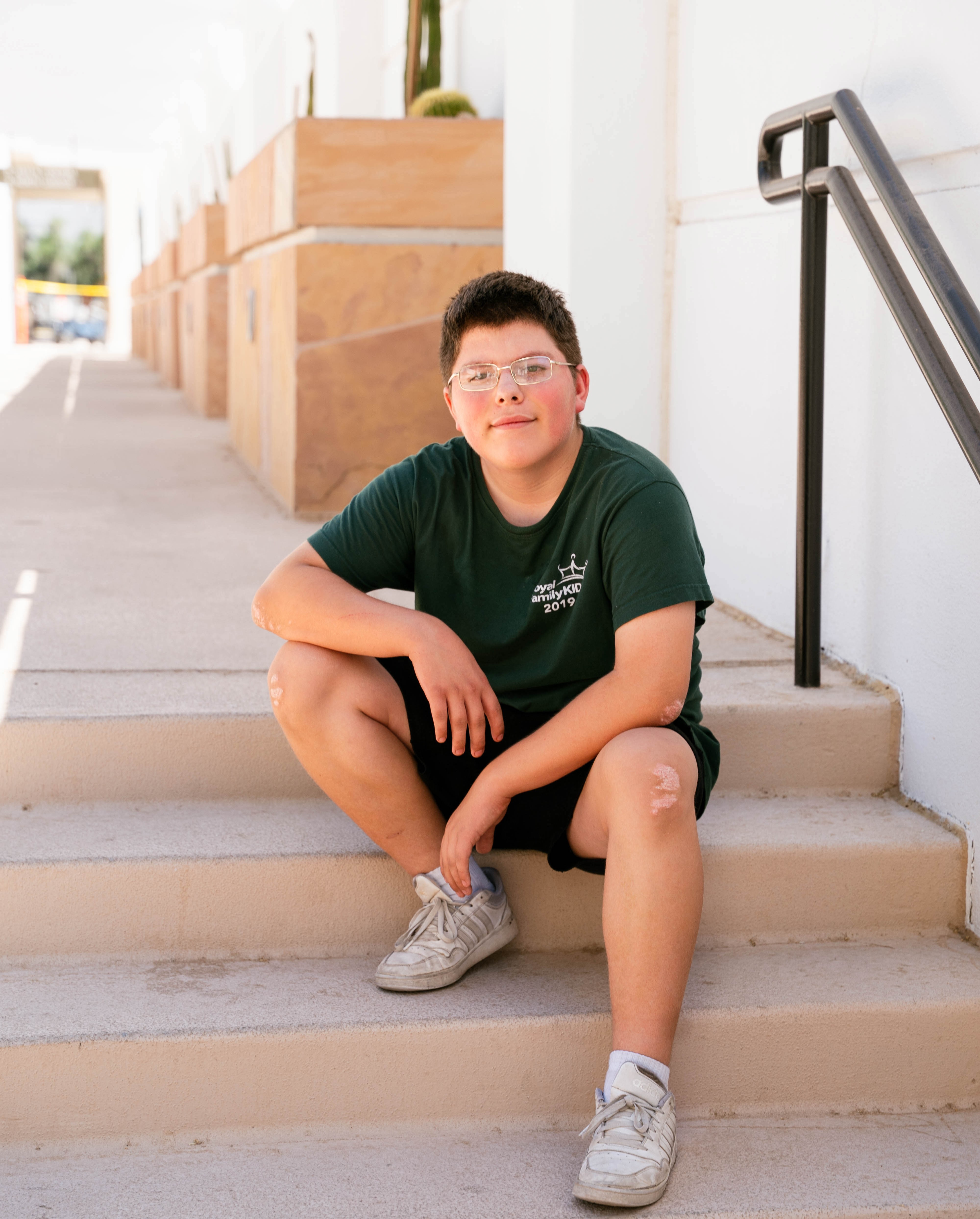 Julyus sitting on steps