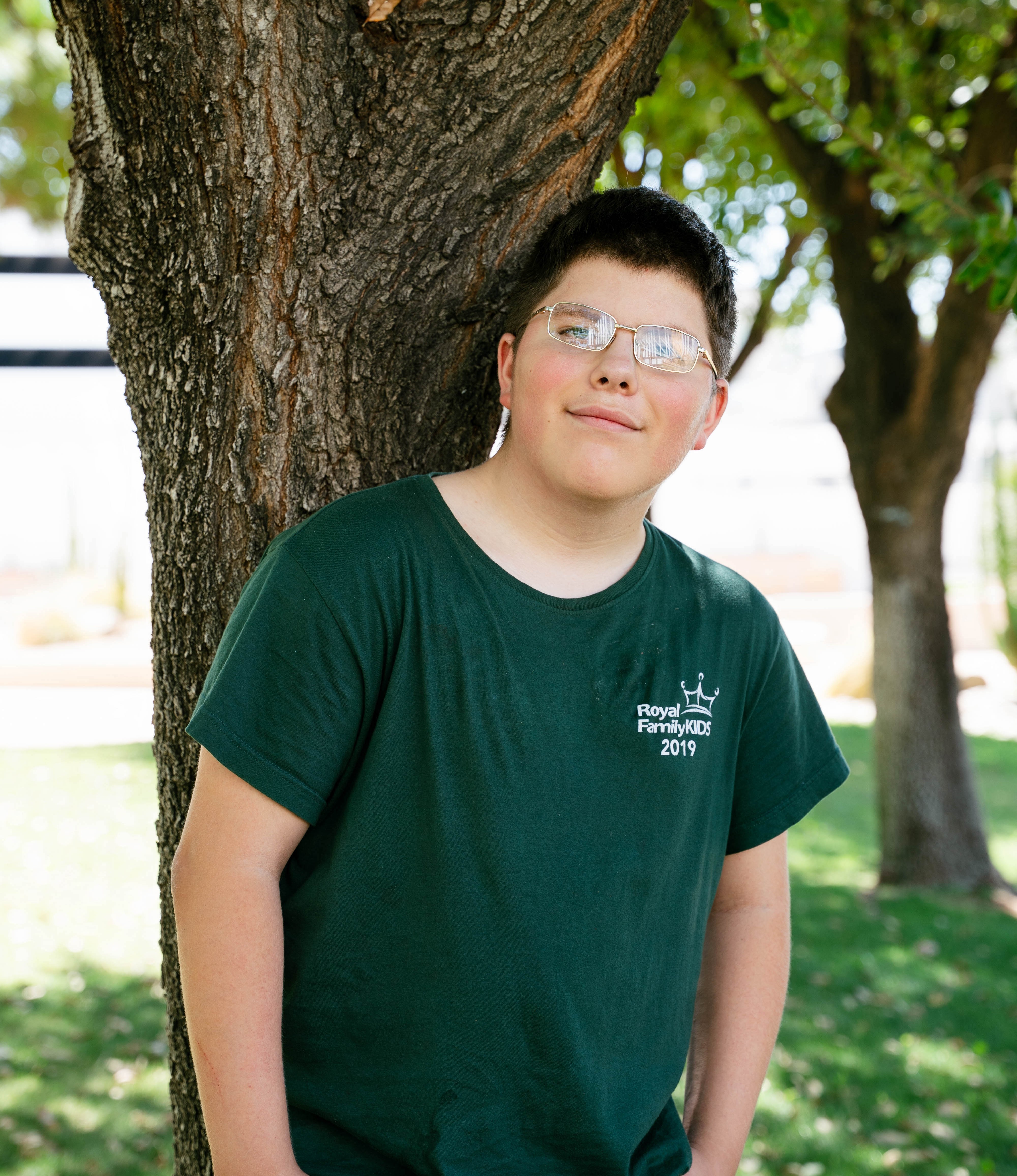 Julyus standing by tree smiling
