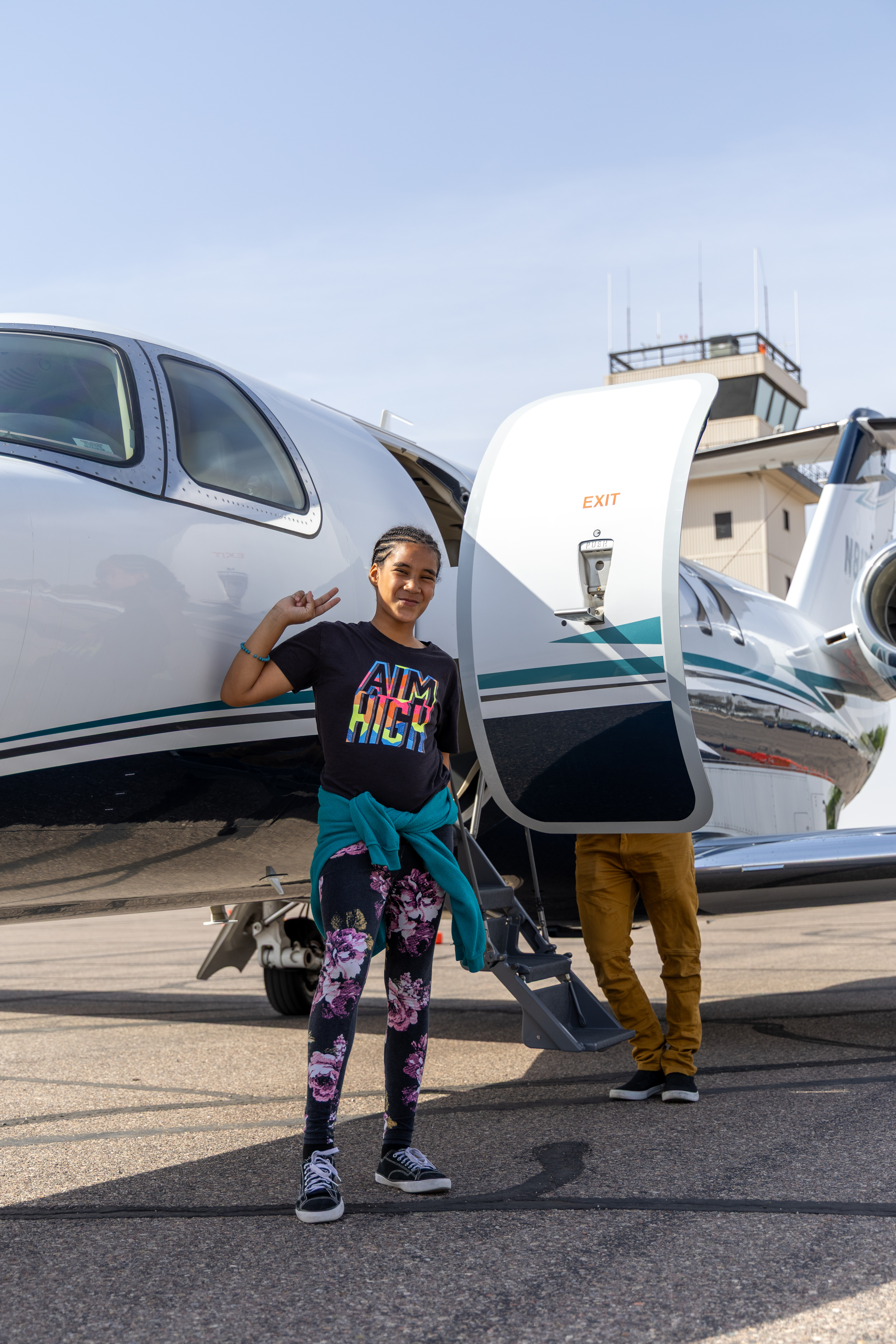 Leilani standing by plane 