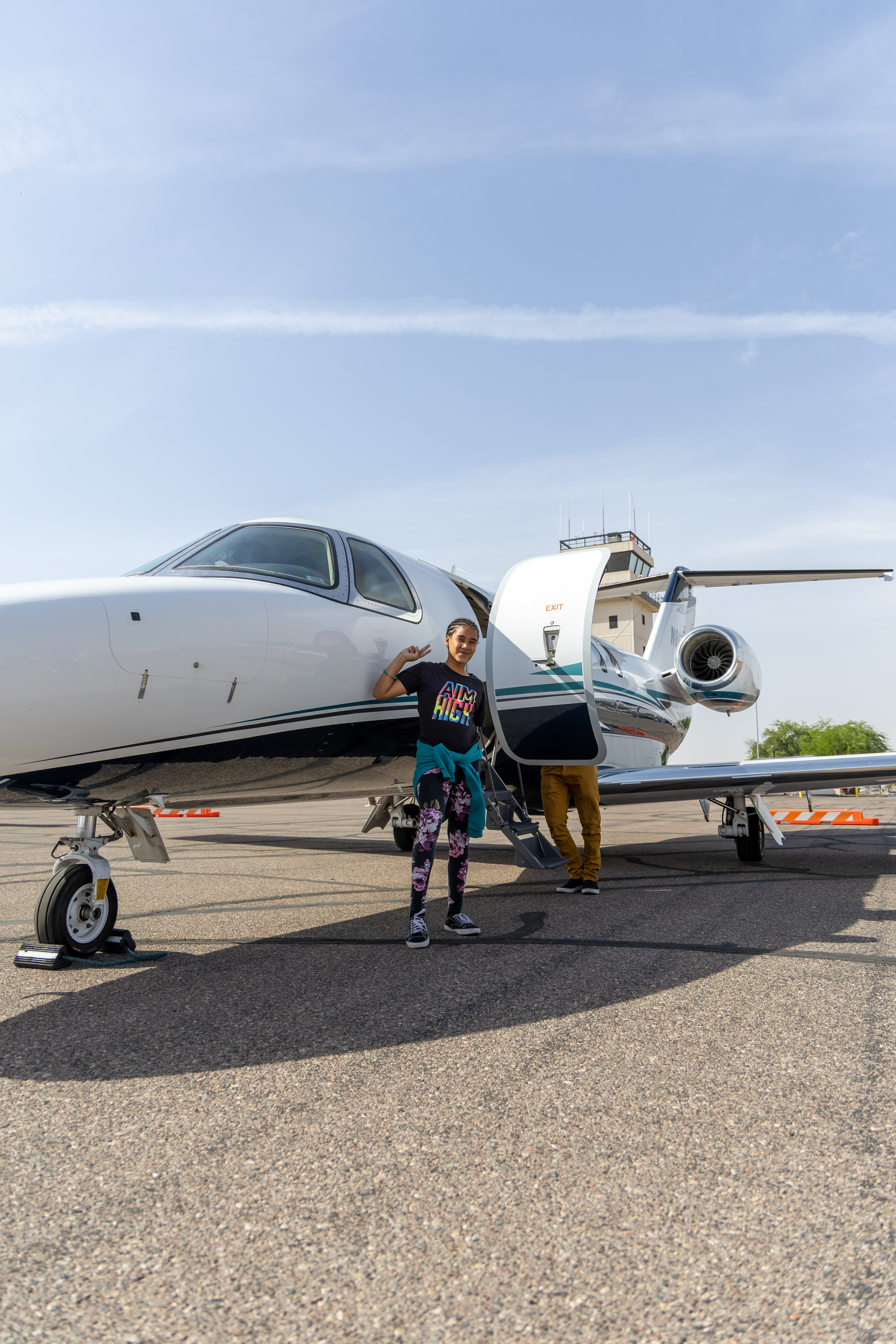 Leilani standing by plane