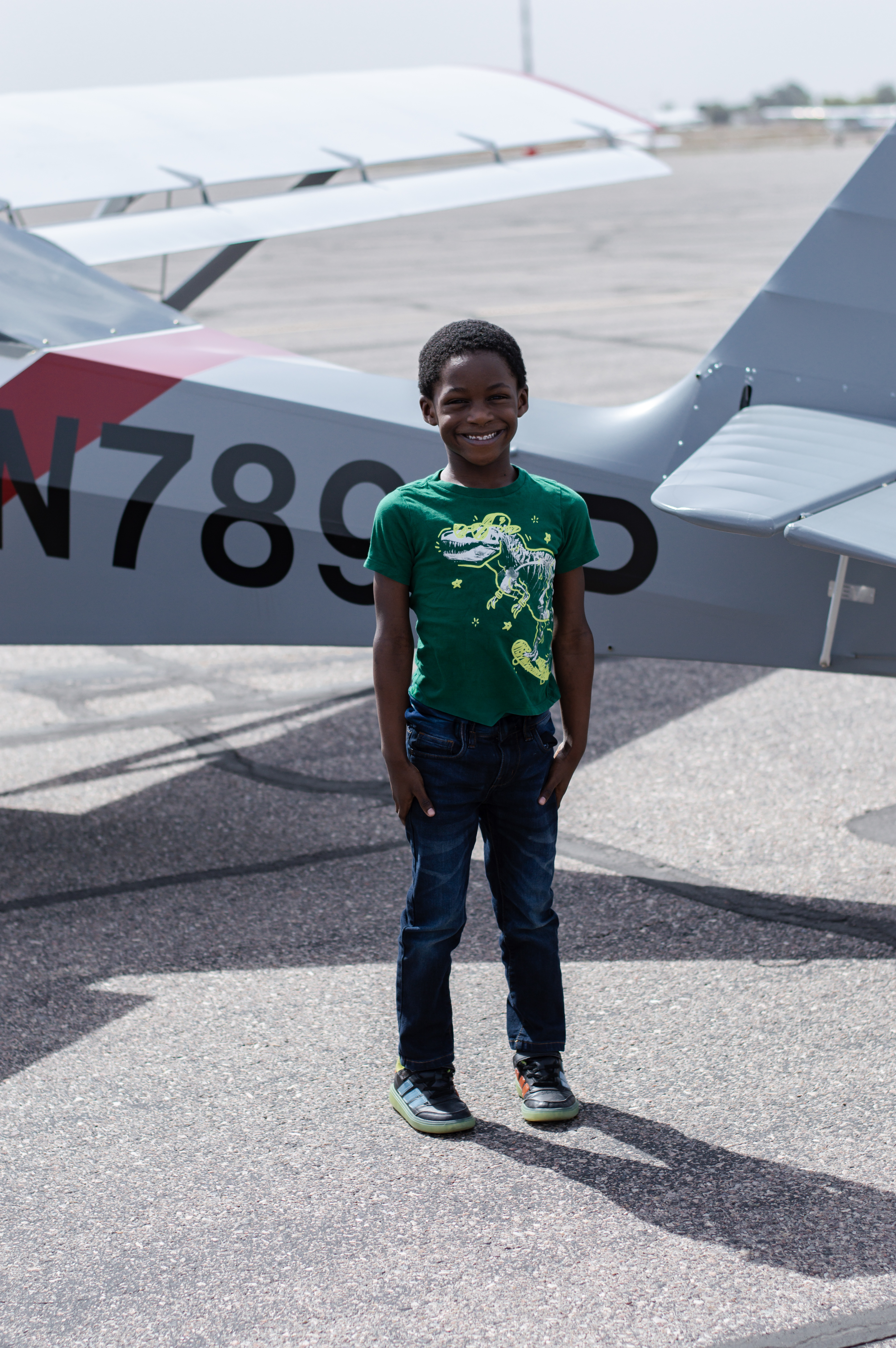 Messiah standing infront of the back end of a plane