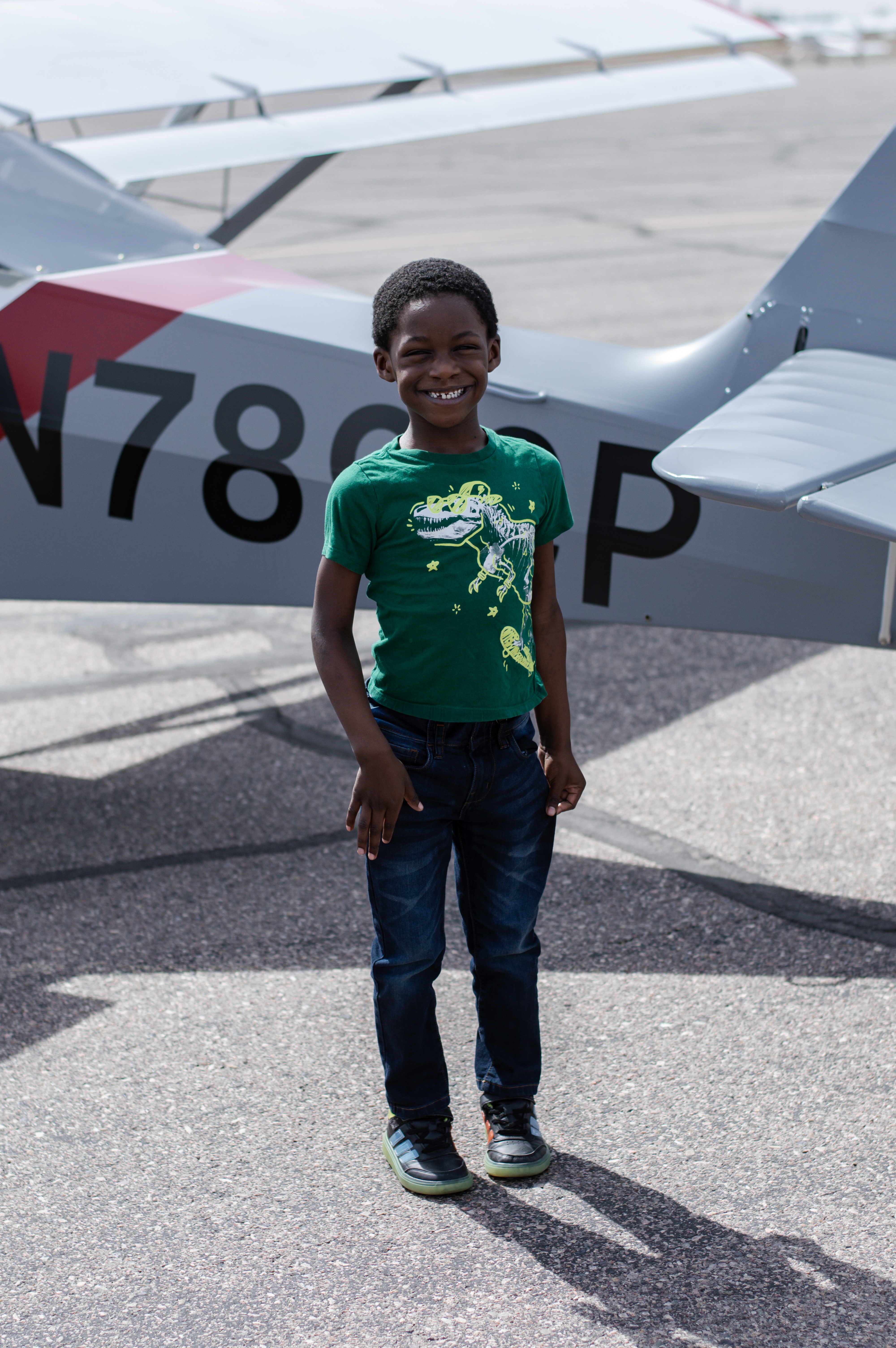 Messiah standing by plane and smiling