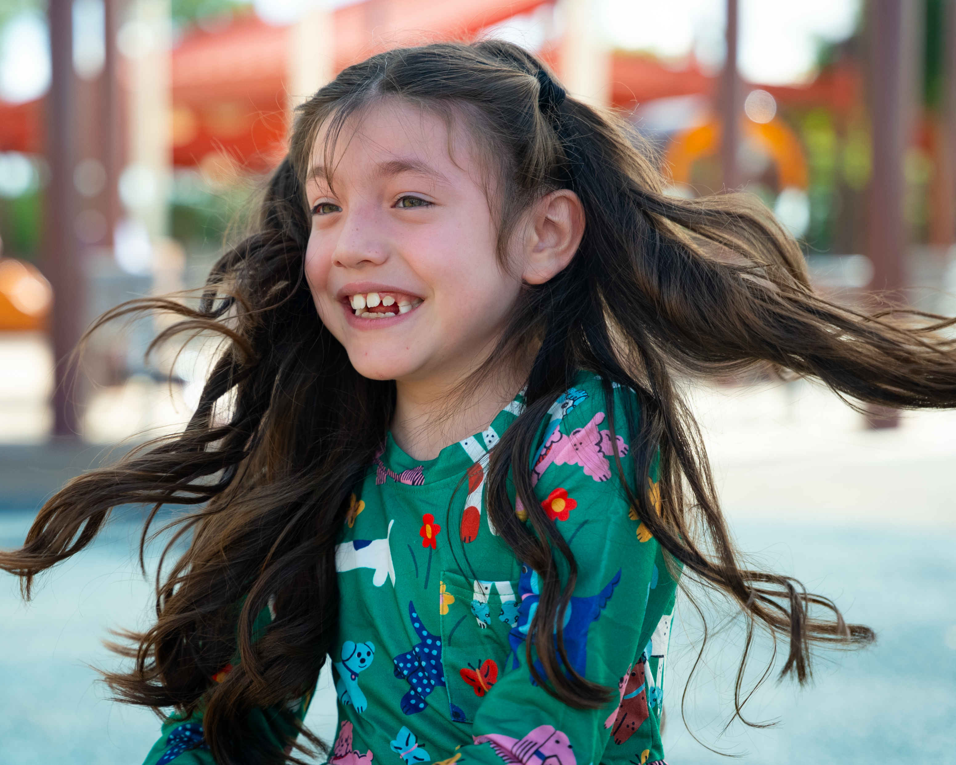 Samantha twirling on playground