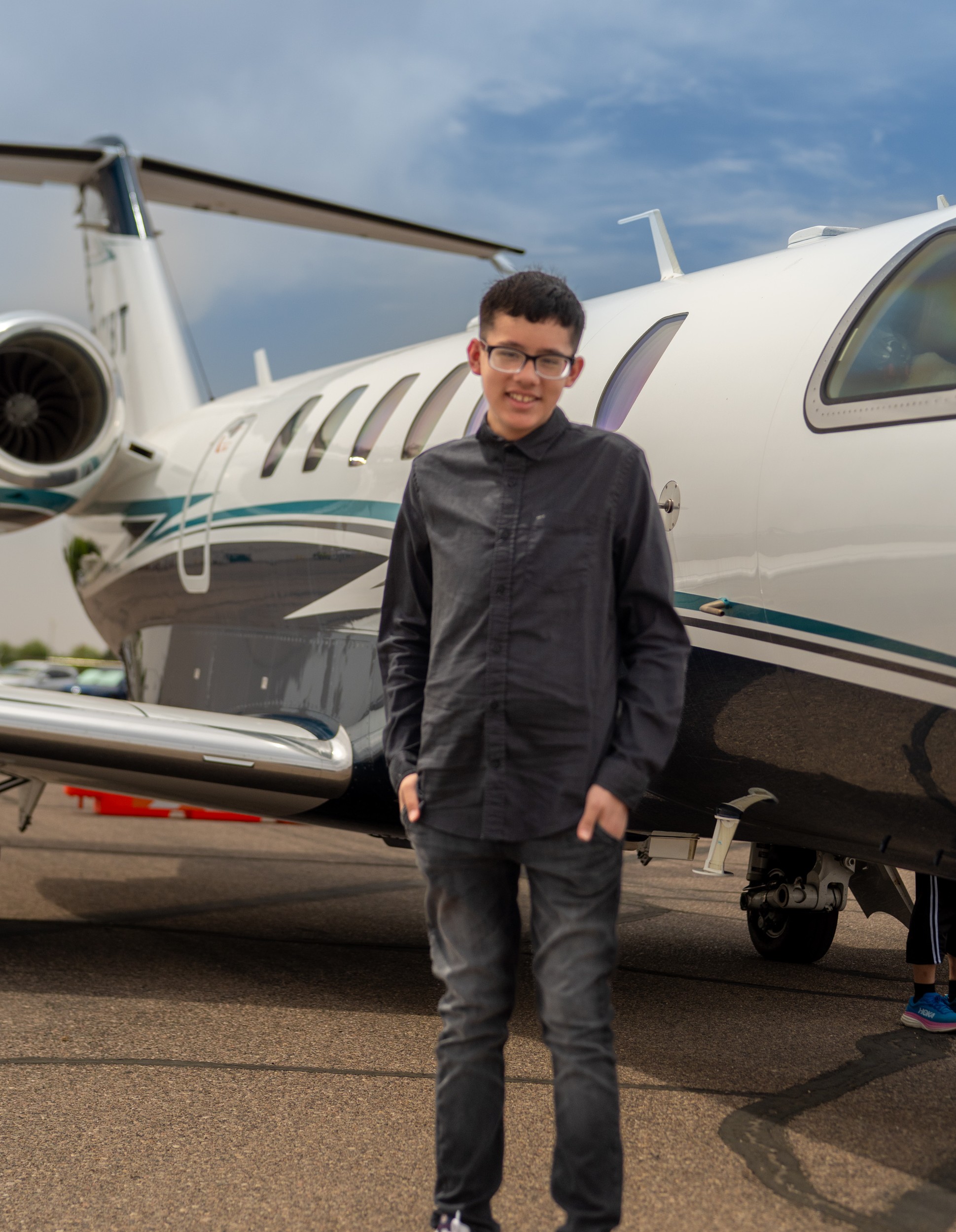 Samuel standing next to plane