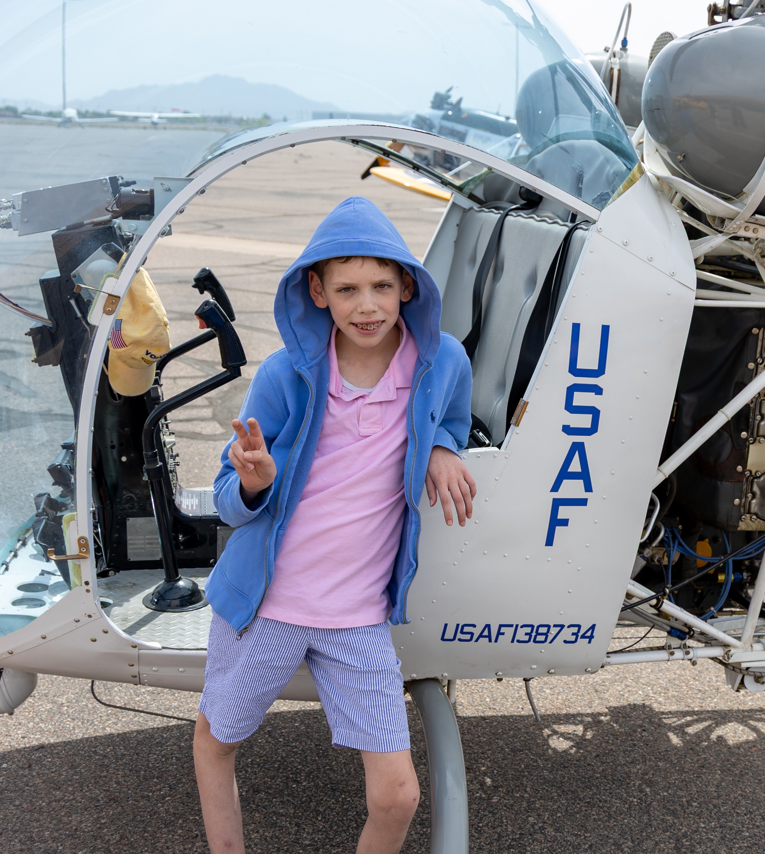 Tauke standing next to helicopter