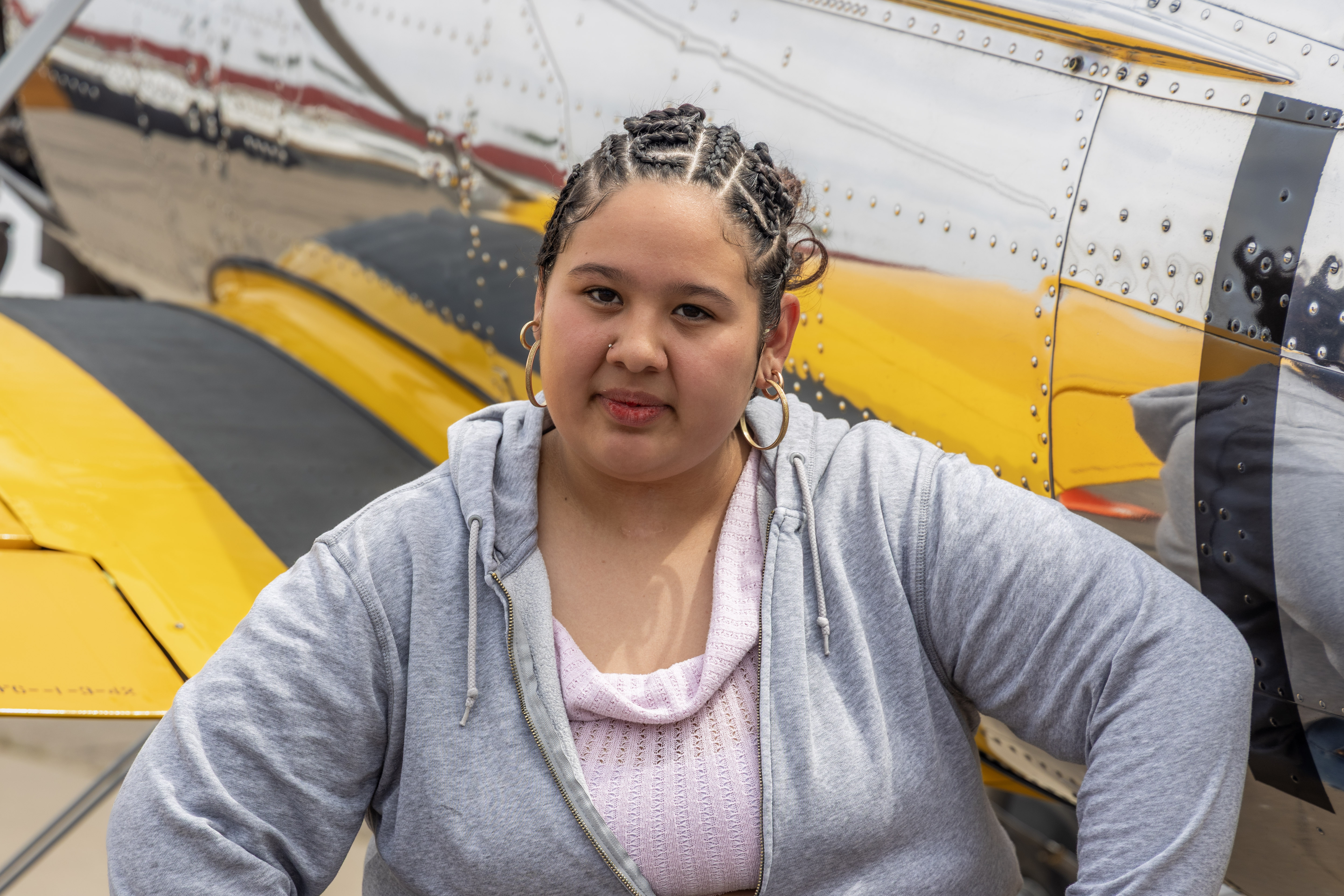 Adriana (Paulina) in front of yellow and black plane