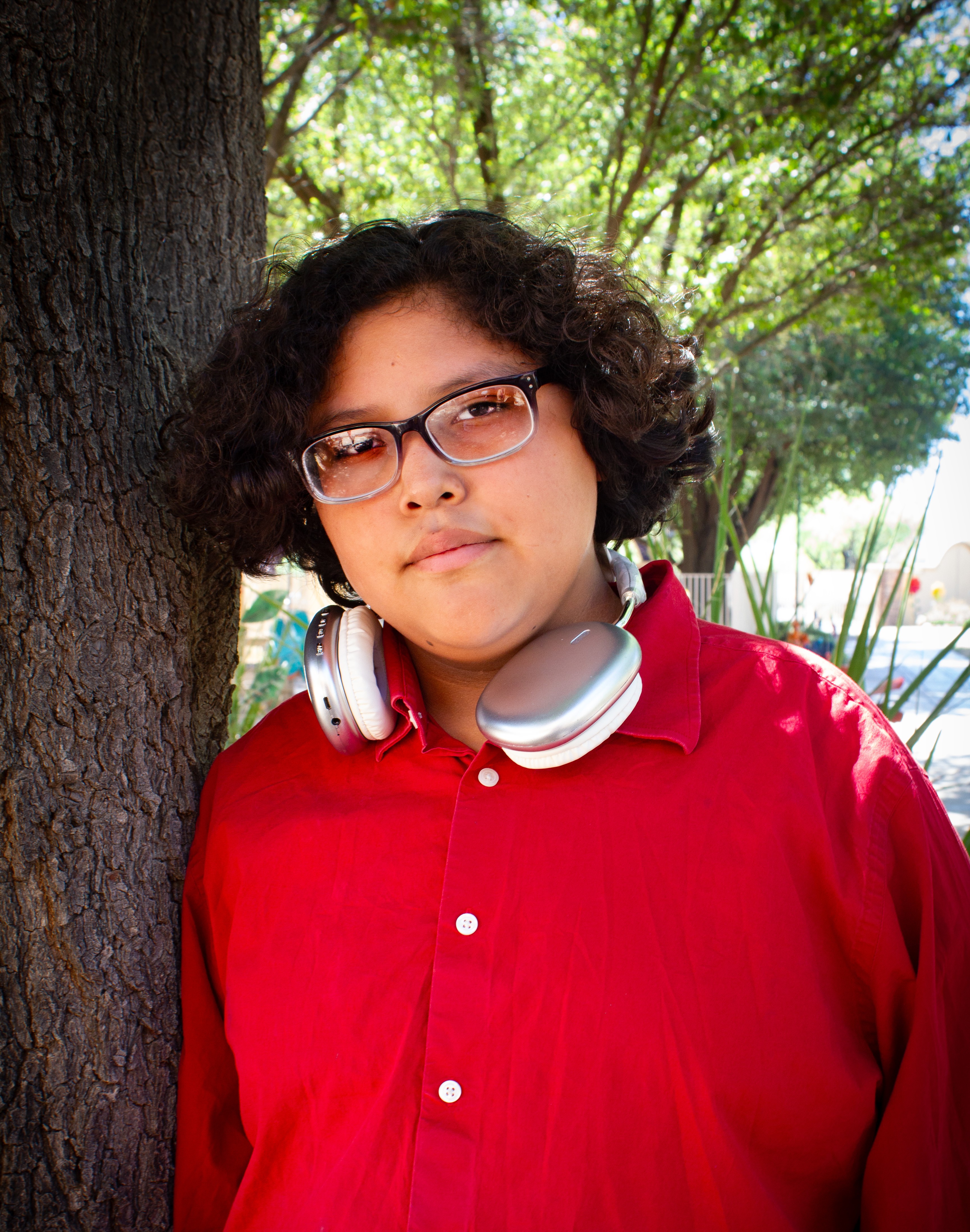 Adalino leaning on tree
