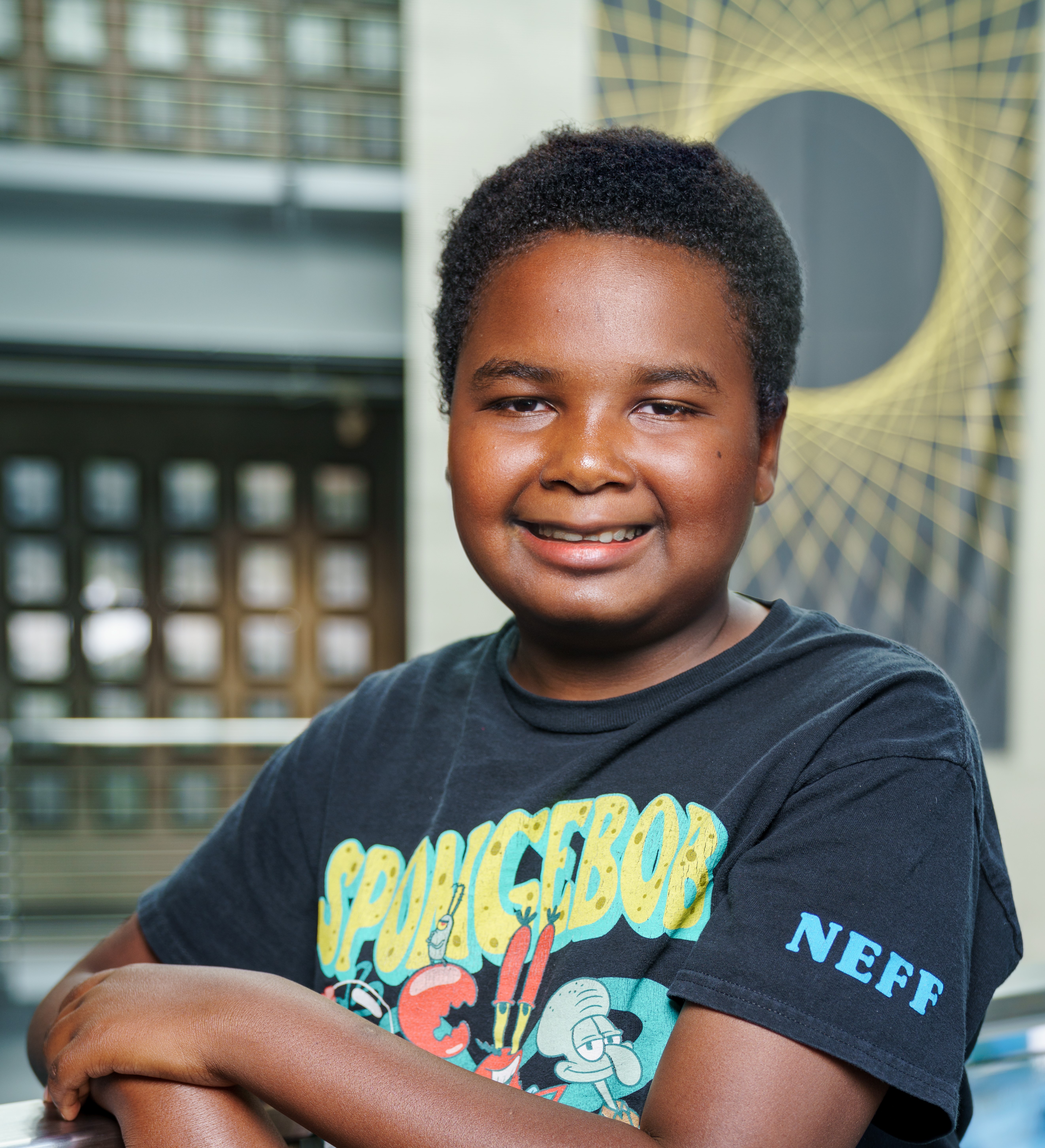 Latrell with latice type banner in background
