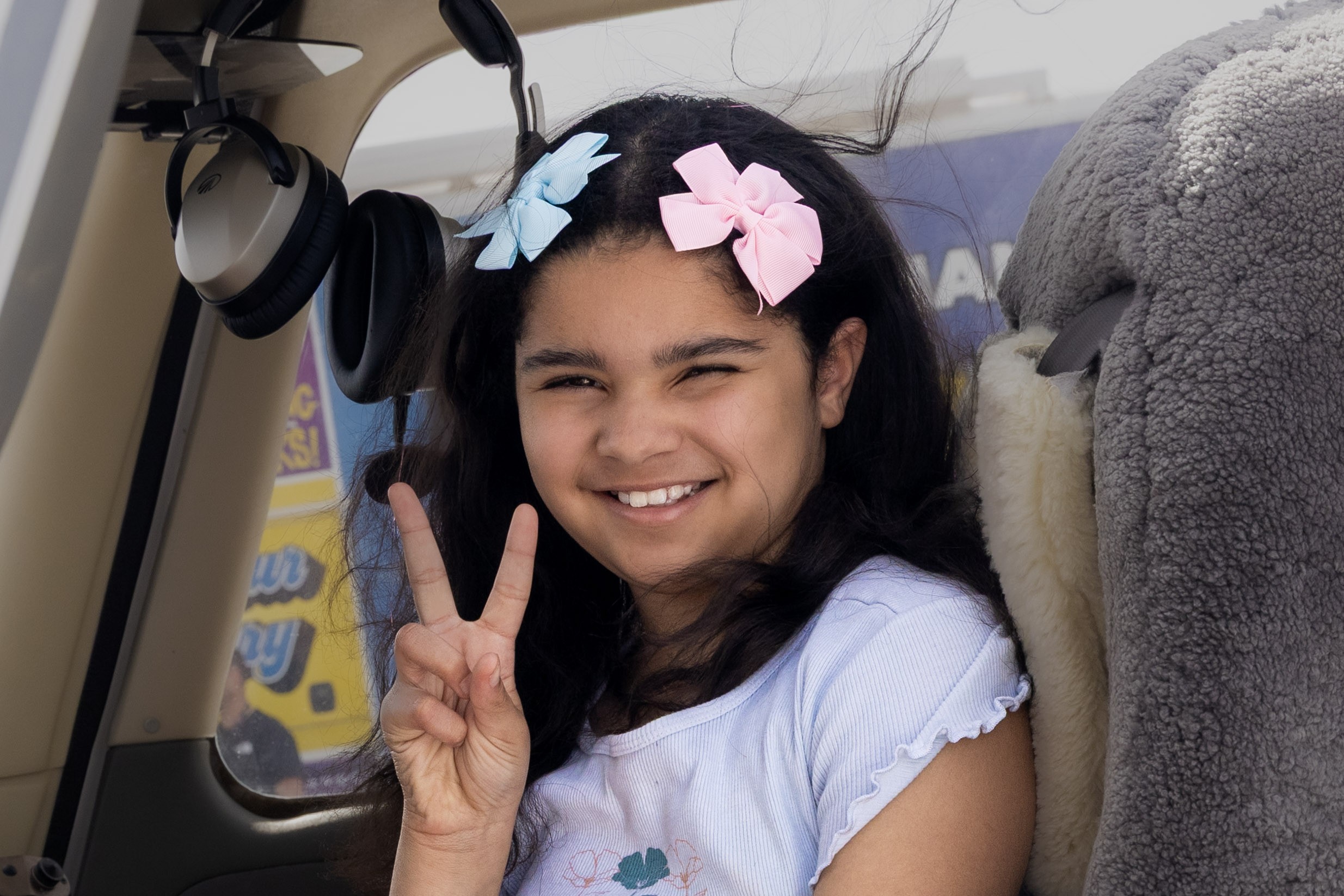 Adaleya sitting in plane smiling