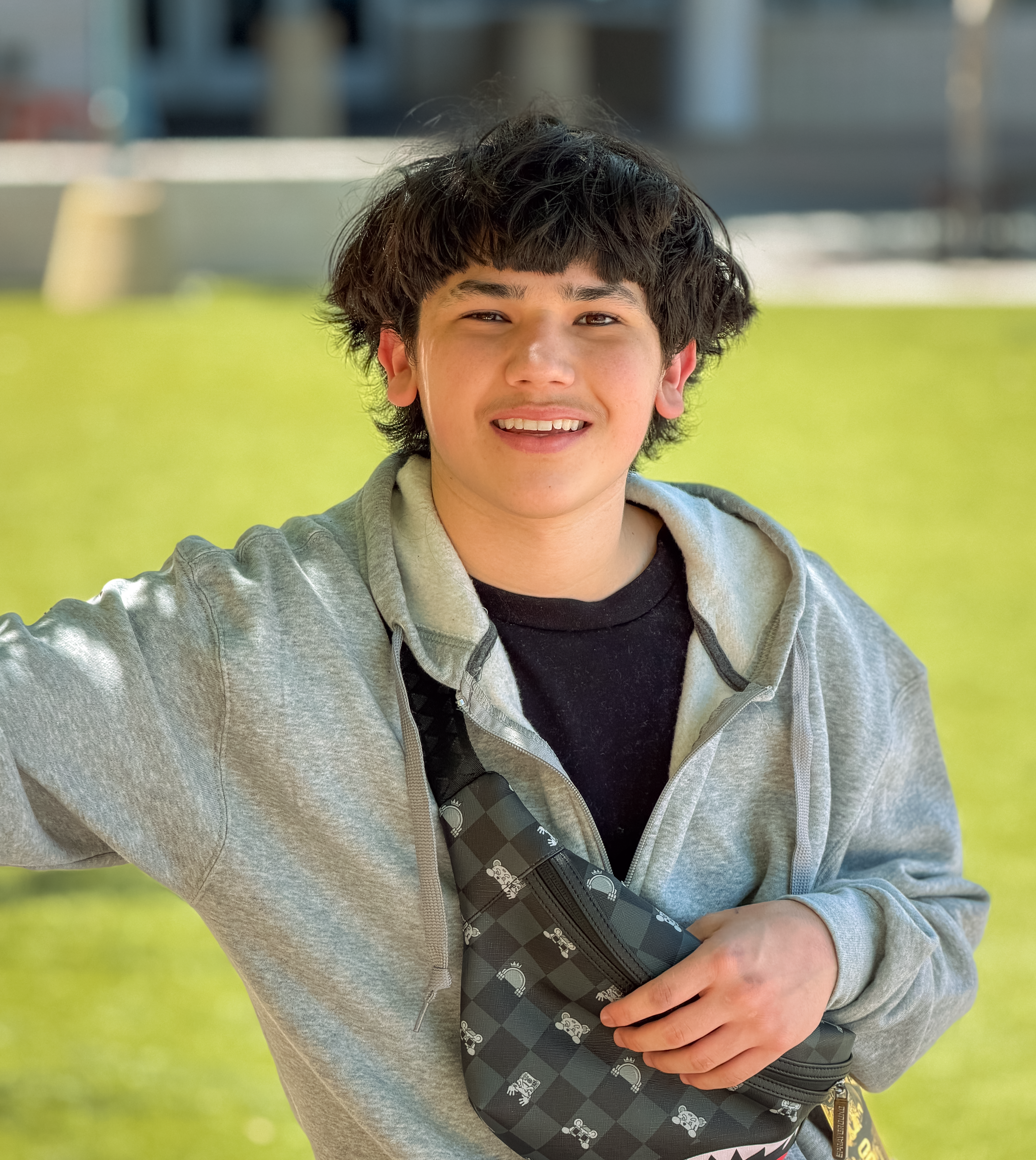 Angelo standing leaning in grass
