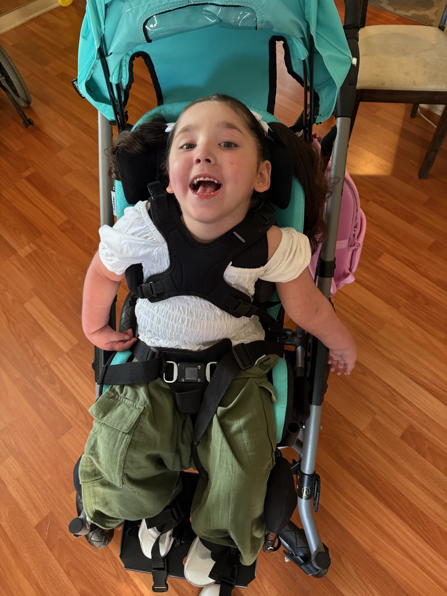 Astrid smiling in wheel chair