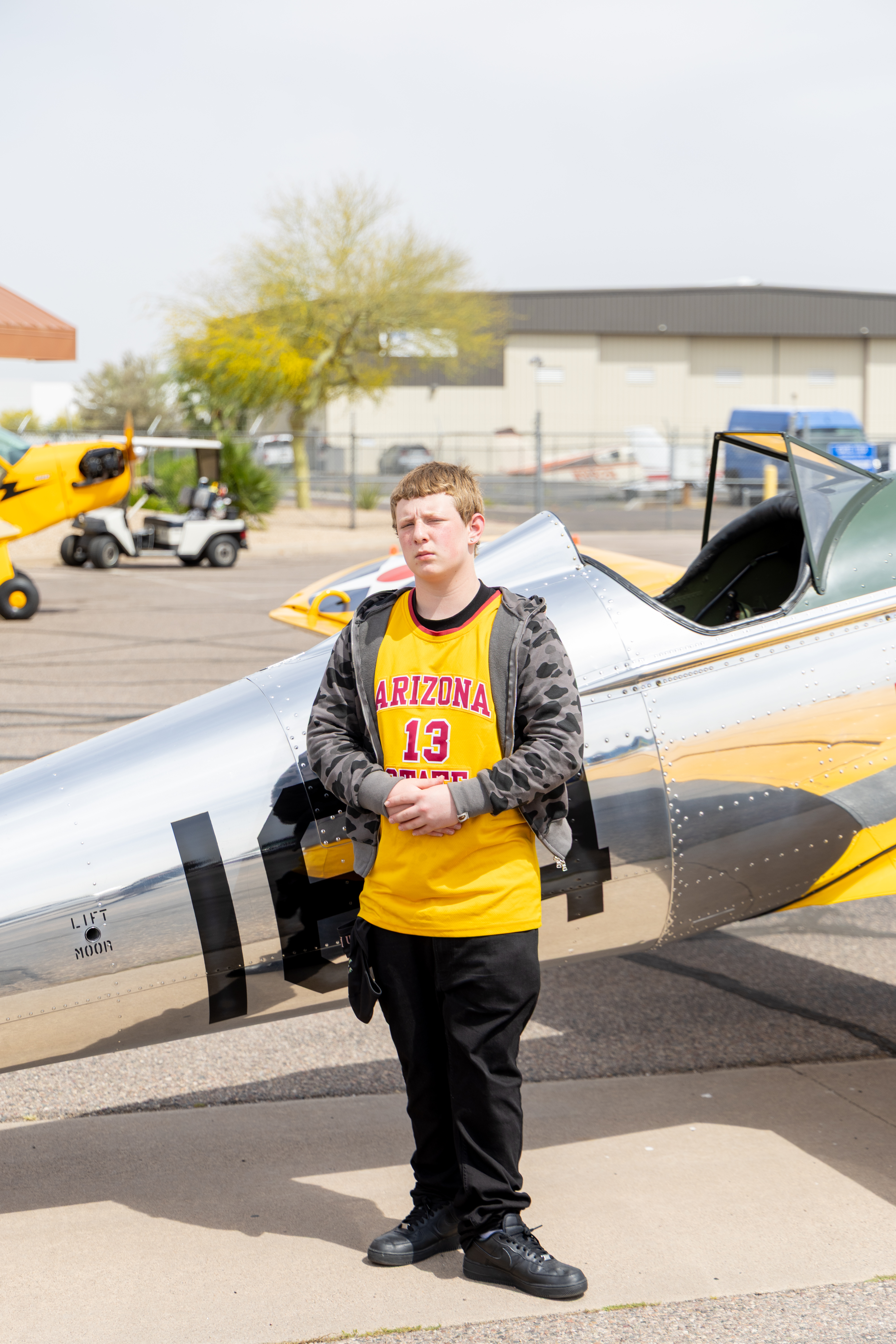 Augustine standing by airplane