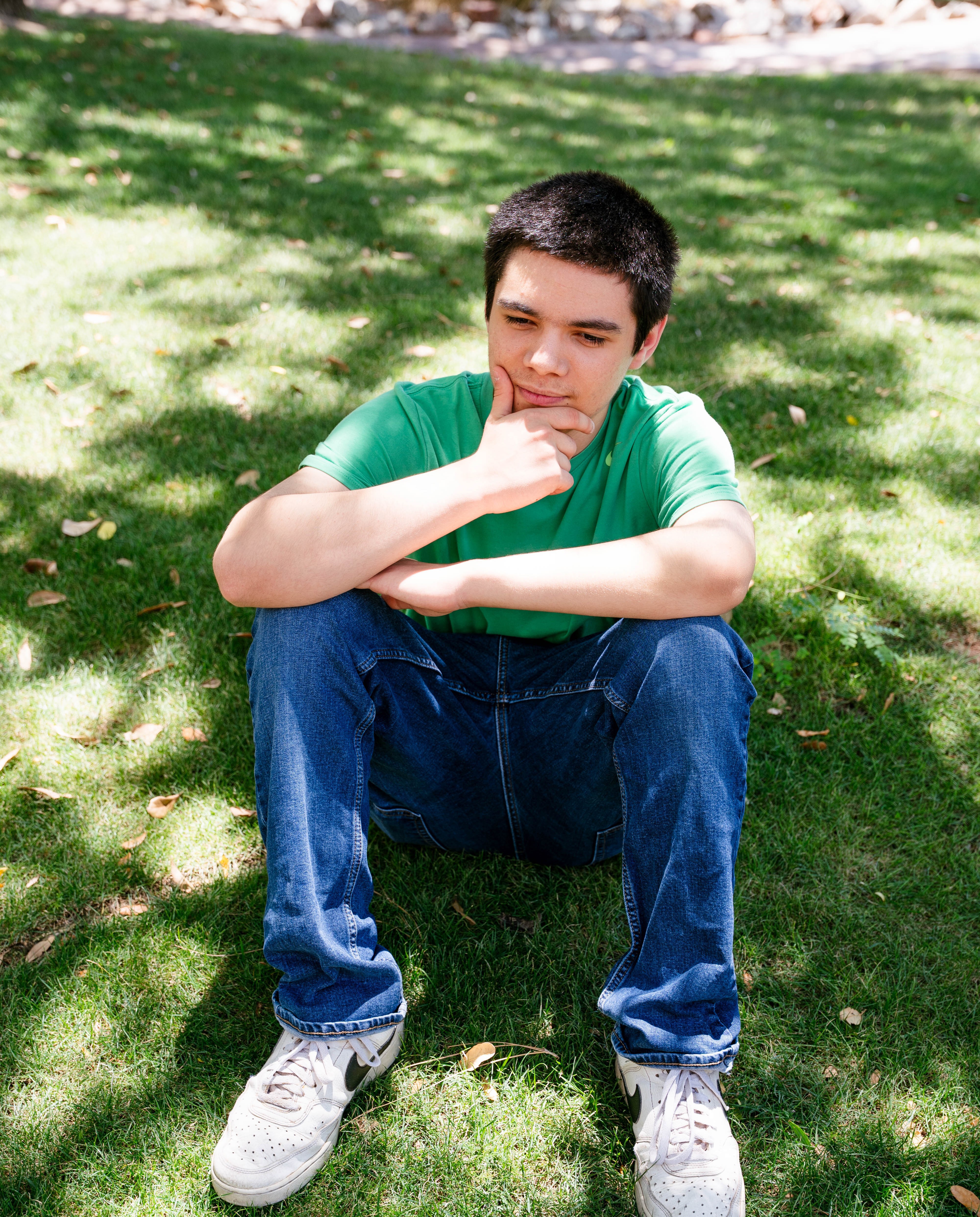 Caleb sitting in grass thinking
