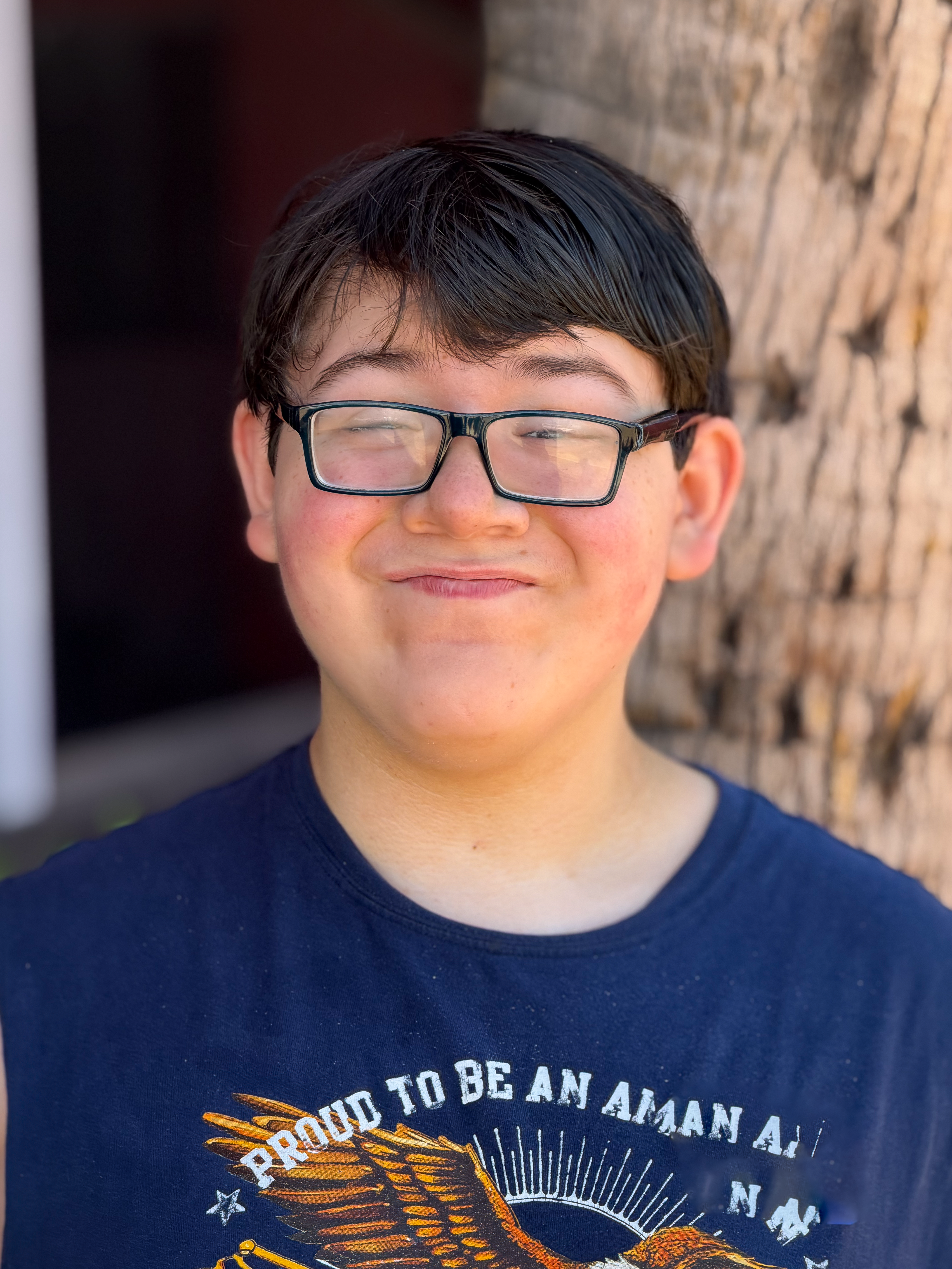 elijah smiling in front of tree