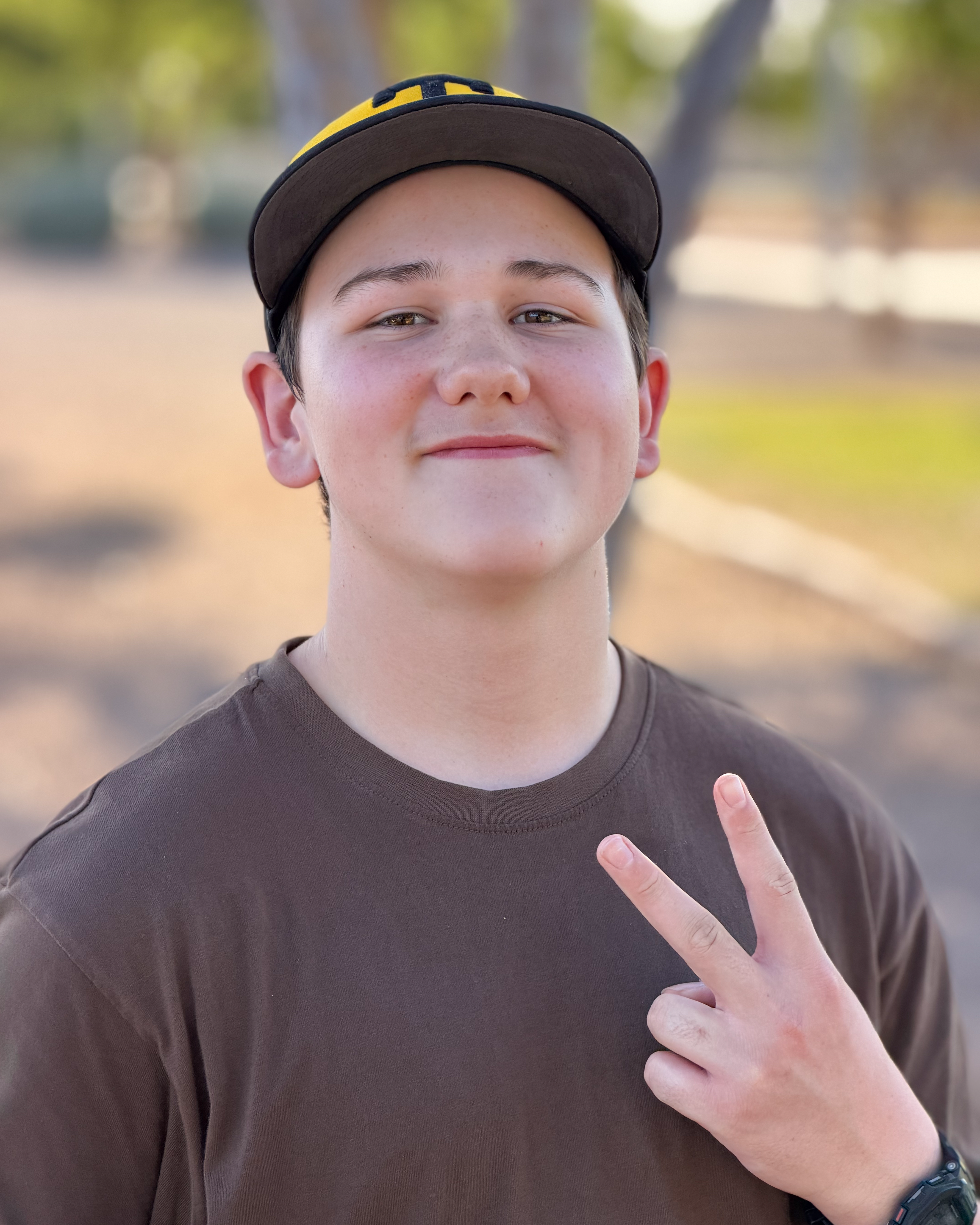 Greyson smiling with peace sign