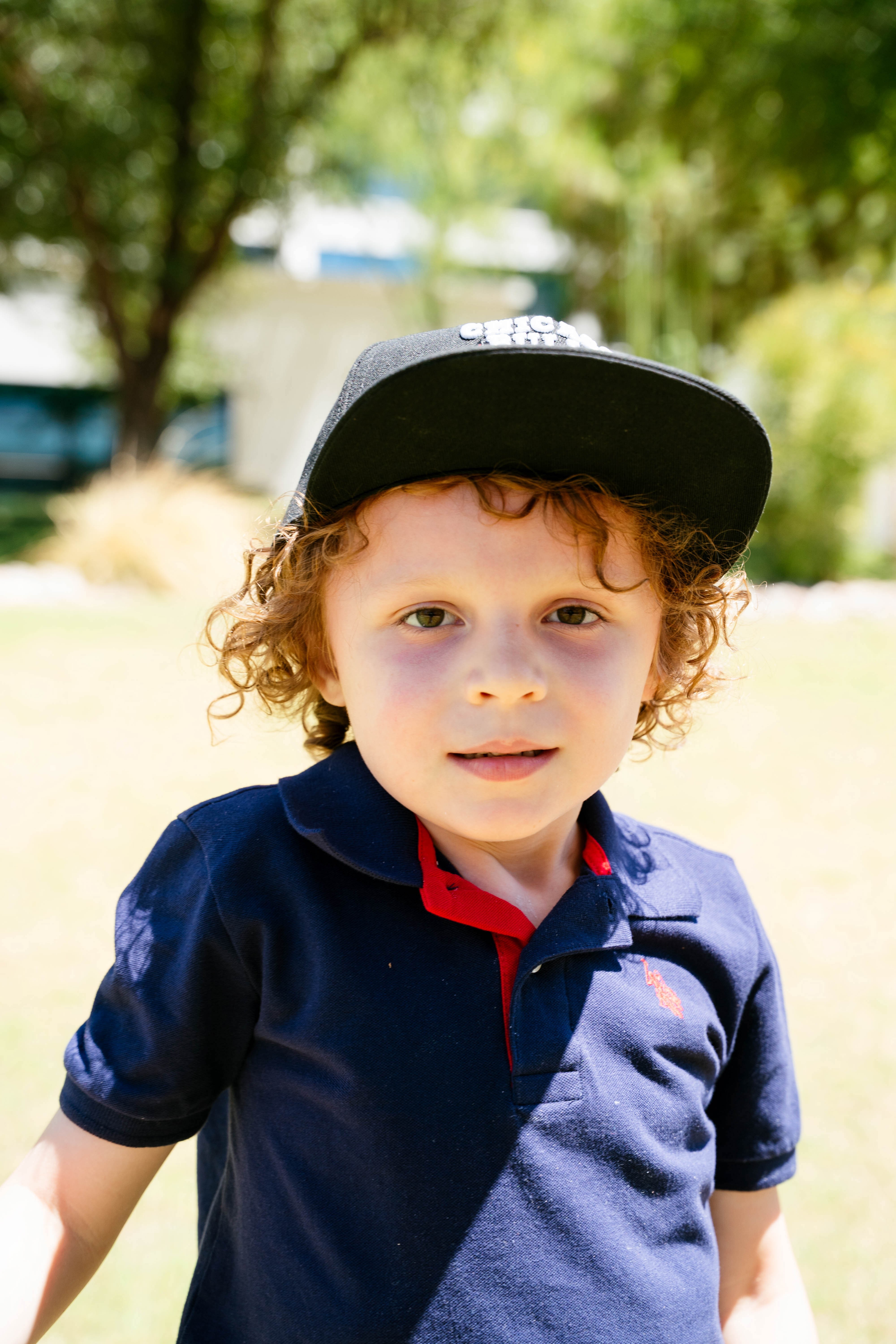 Kash with hat with trees in background