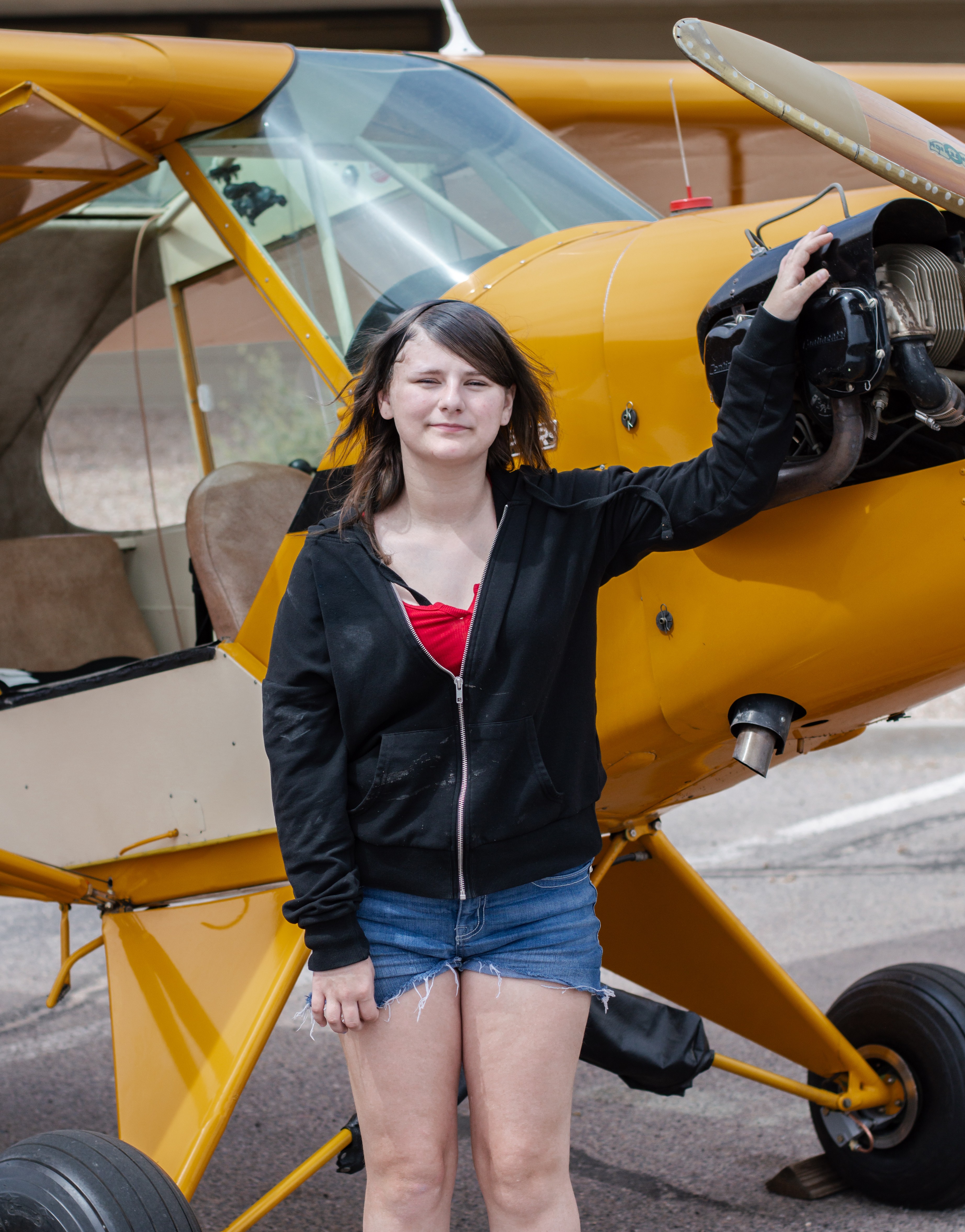 Kaylyn standing by plane
