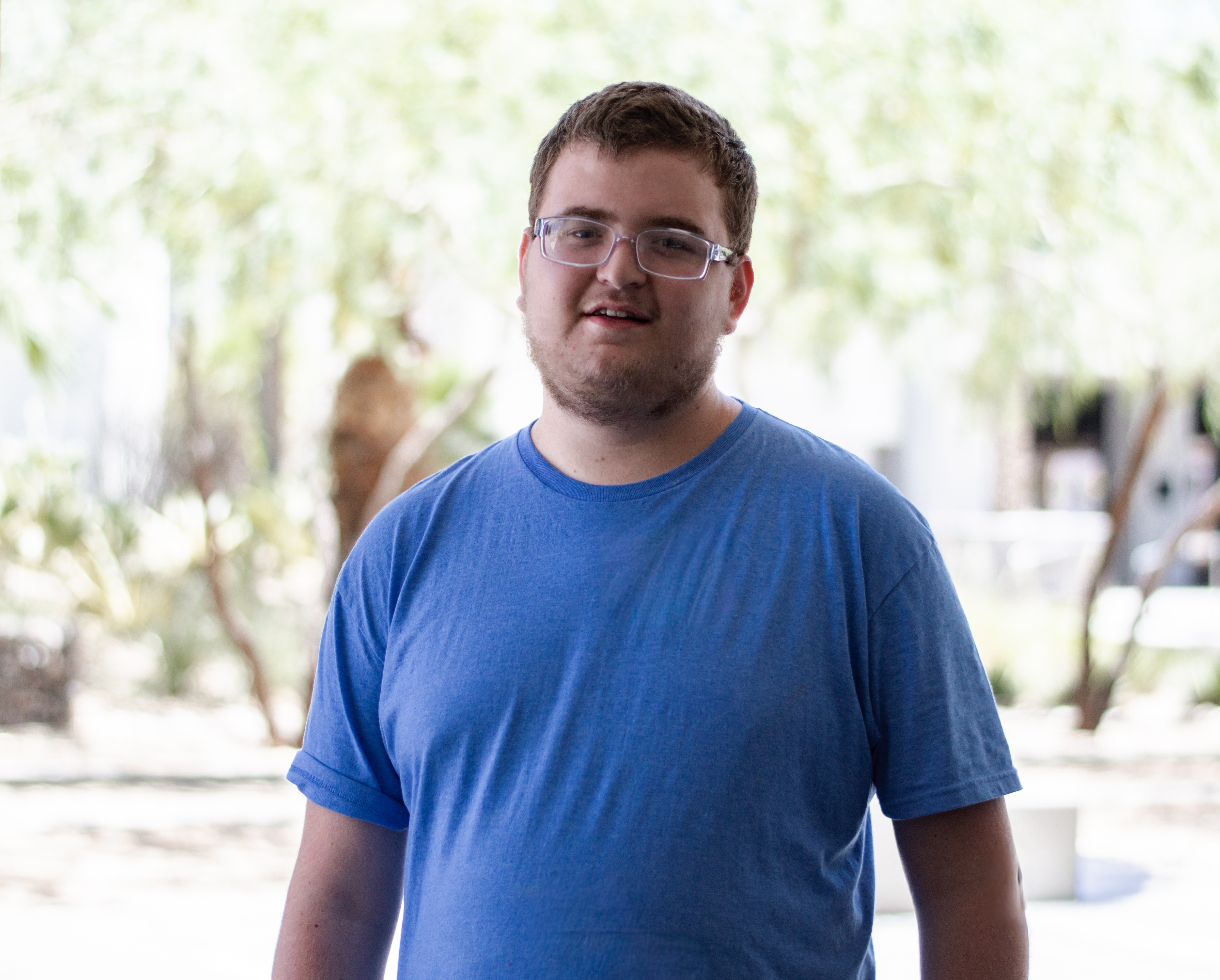 Samuel outside with trees in background