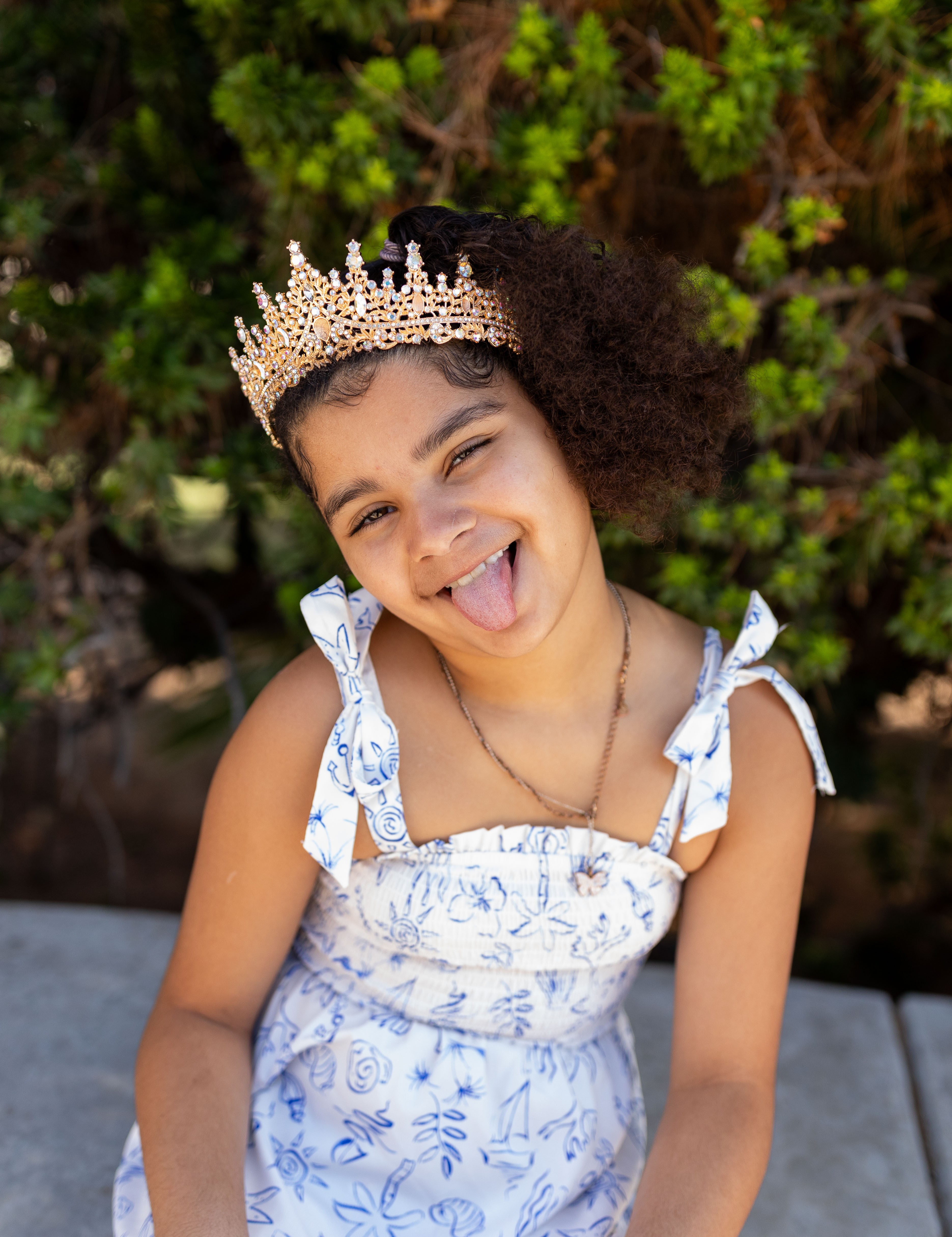 Adaleya sitting posing with her tongue out