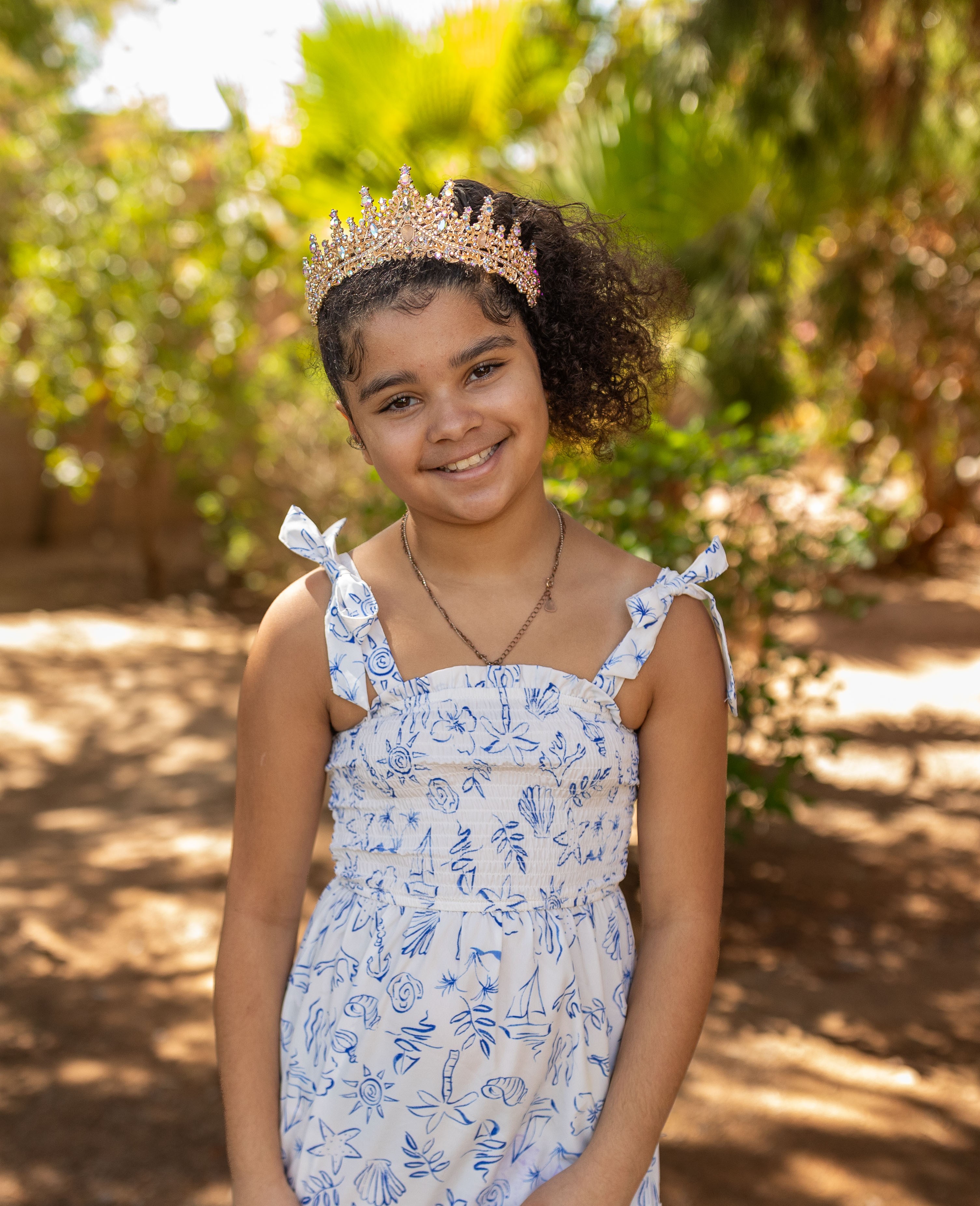 Adaleya standing posing with bushes in background