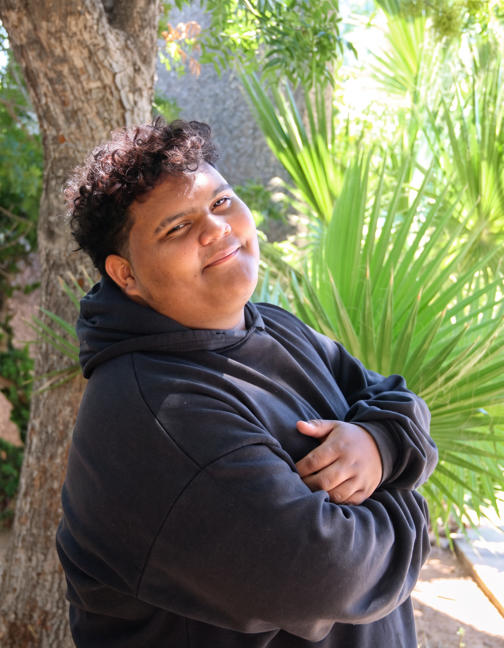 Brayan leaning against a tree
