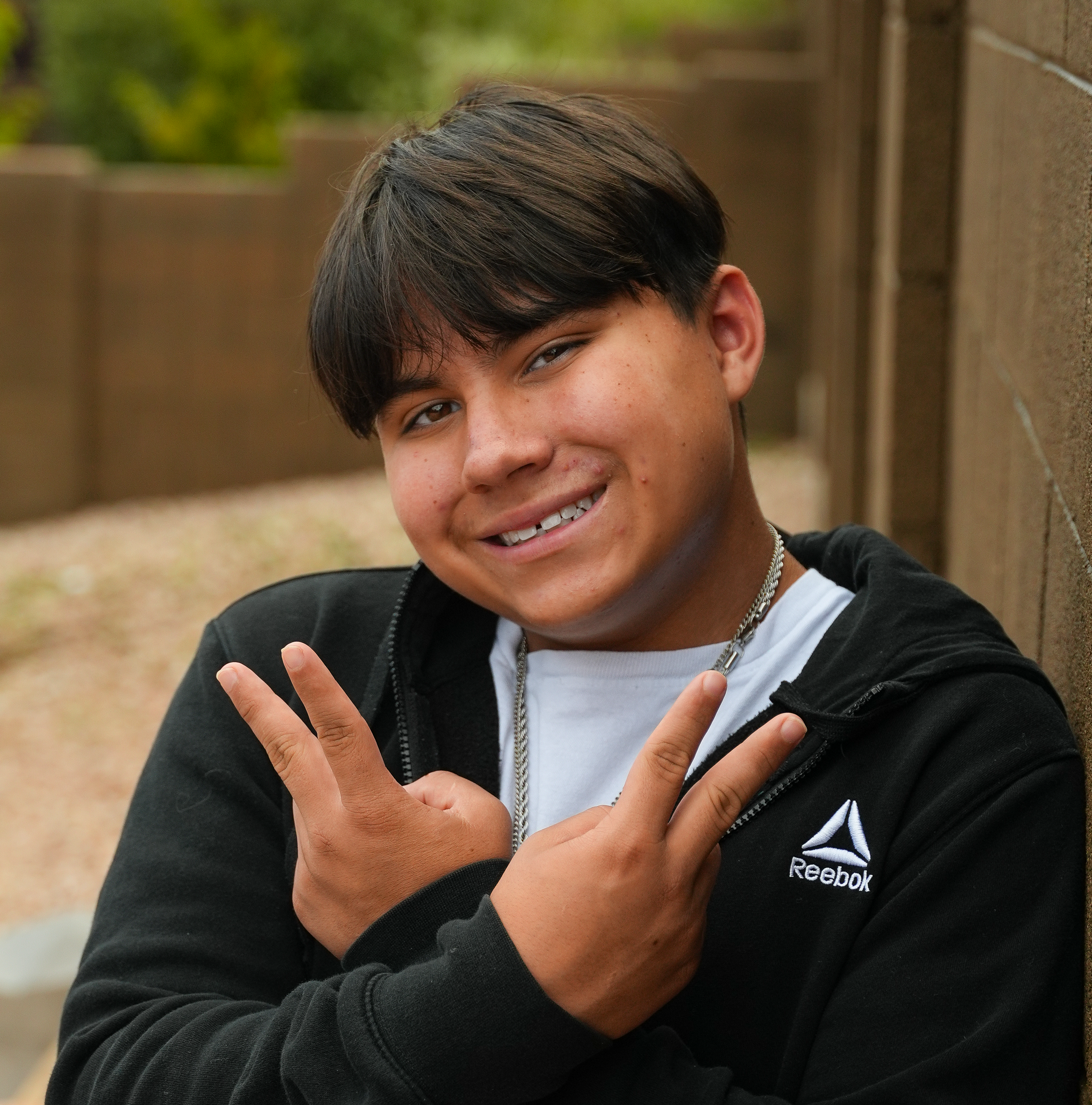 Eliejah smiling with peace sign