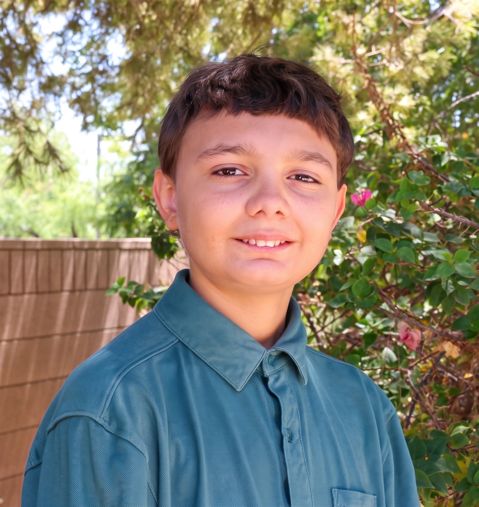 Ethen with wall and trees in background