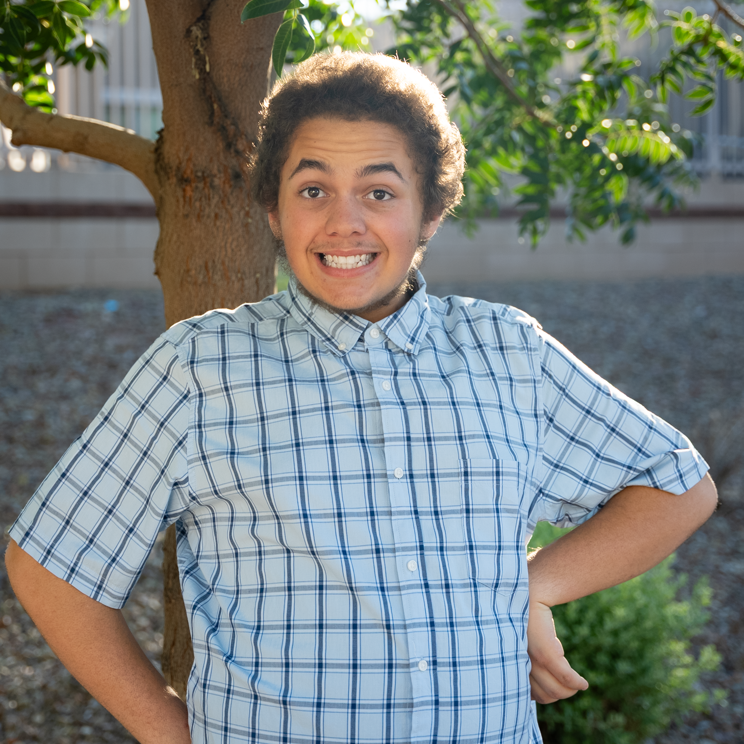Jamarcus with hands on hips smiling