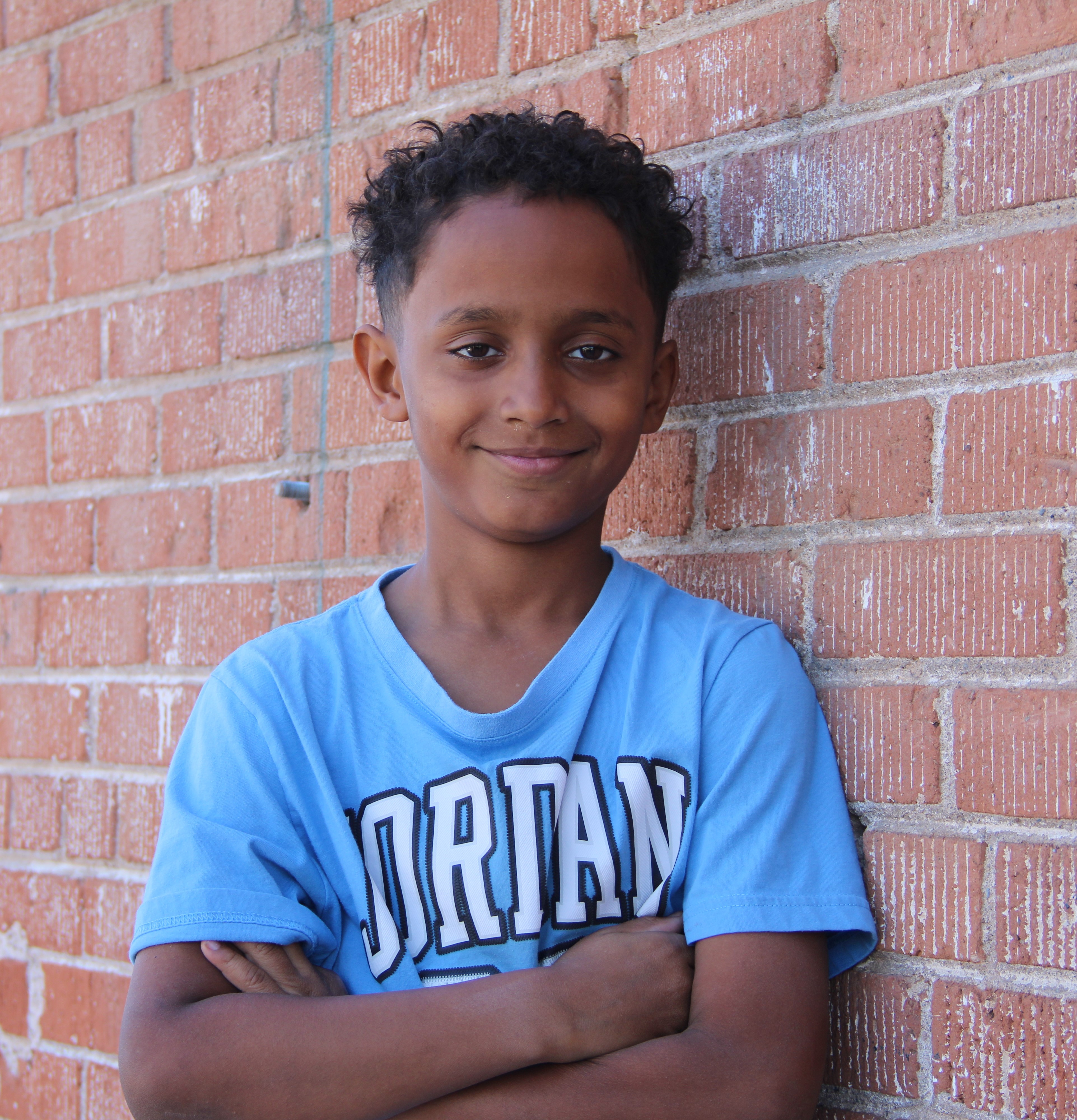 Julian (3) leaning against wall