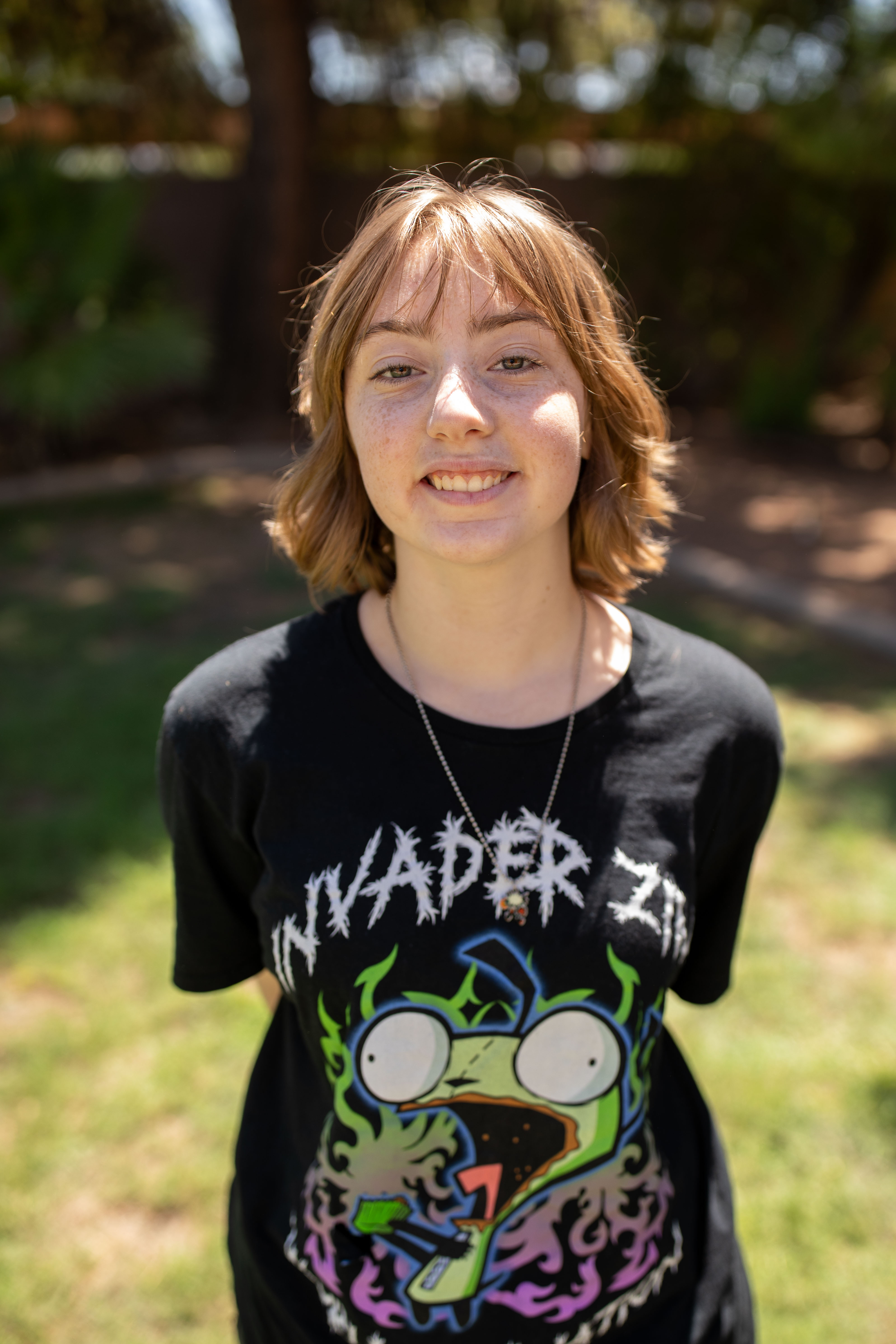 Sara standing smiling with arms behind her