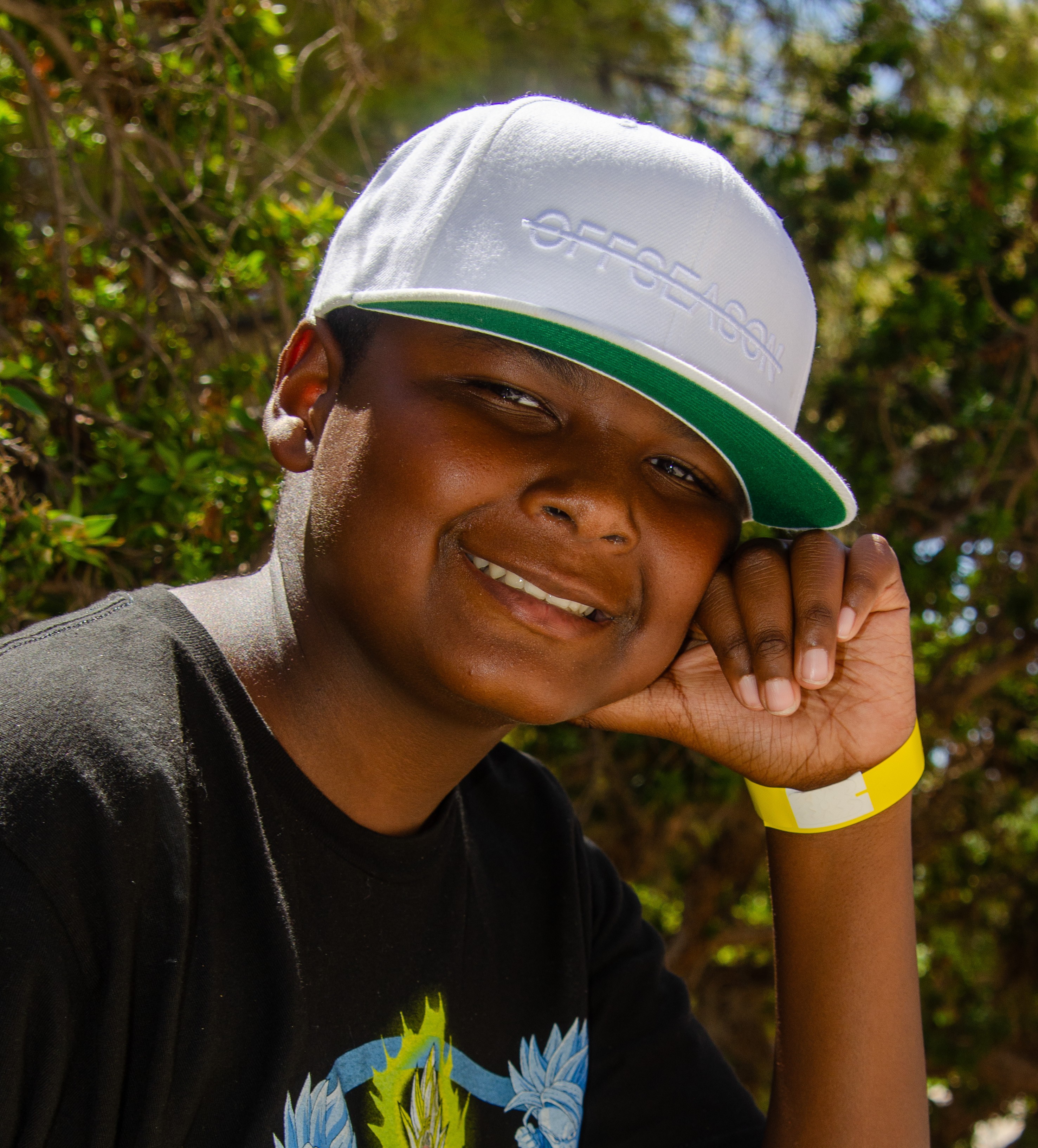Latrell with hand on side of face