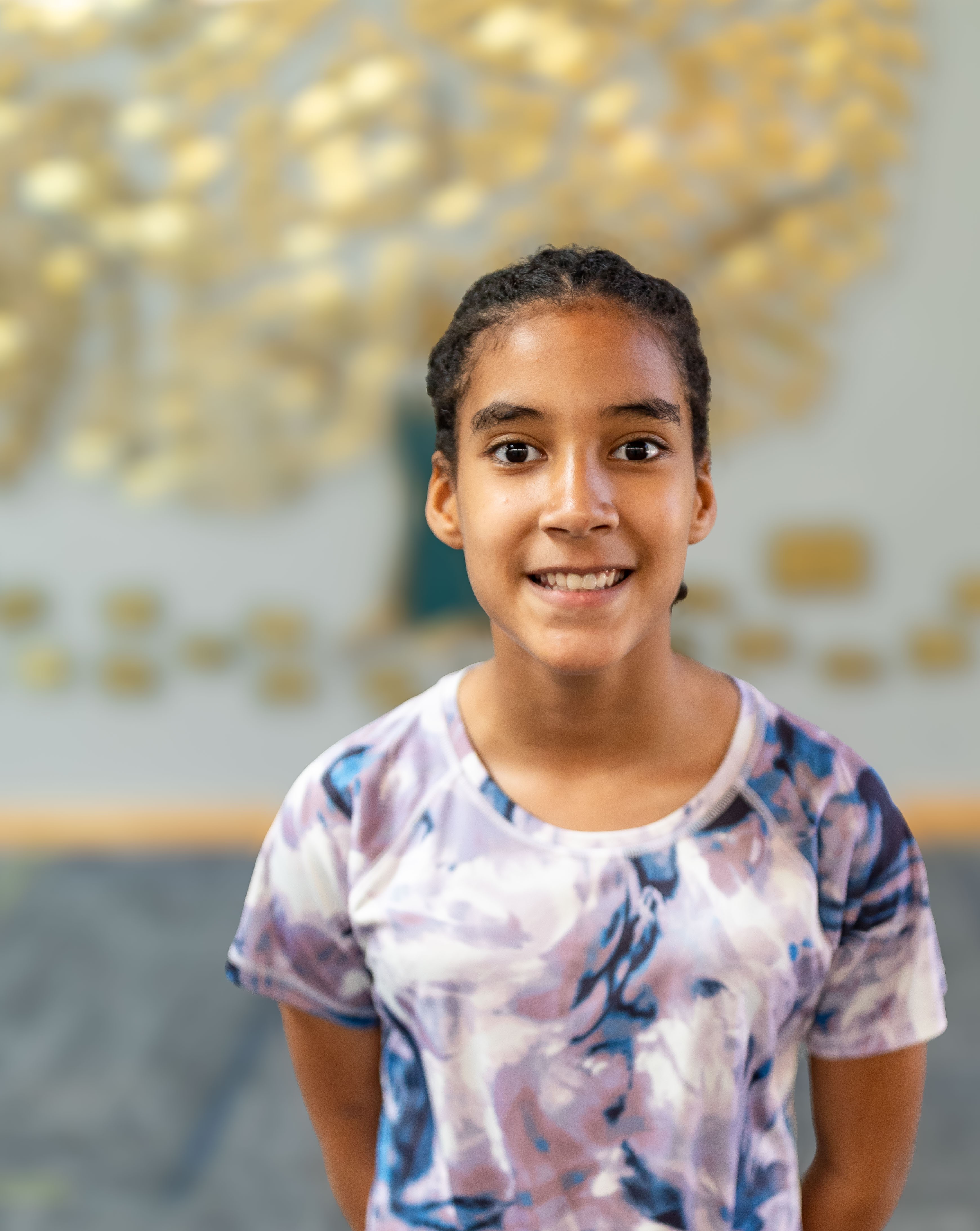 Leilani standing with blurred background smiling