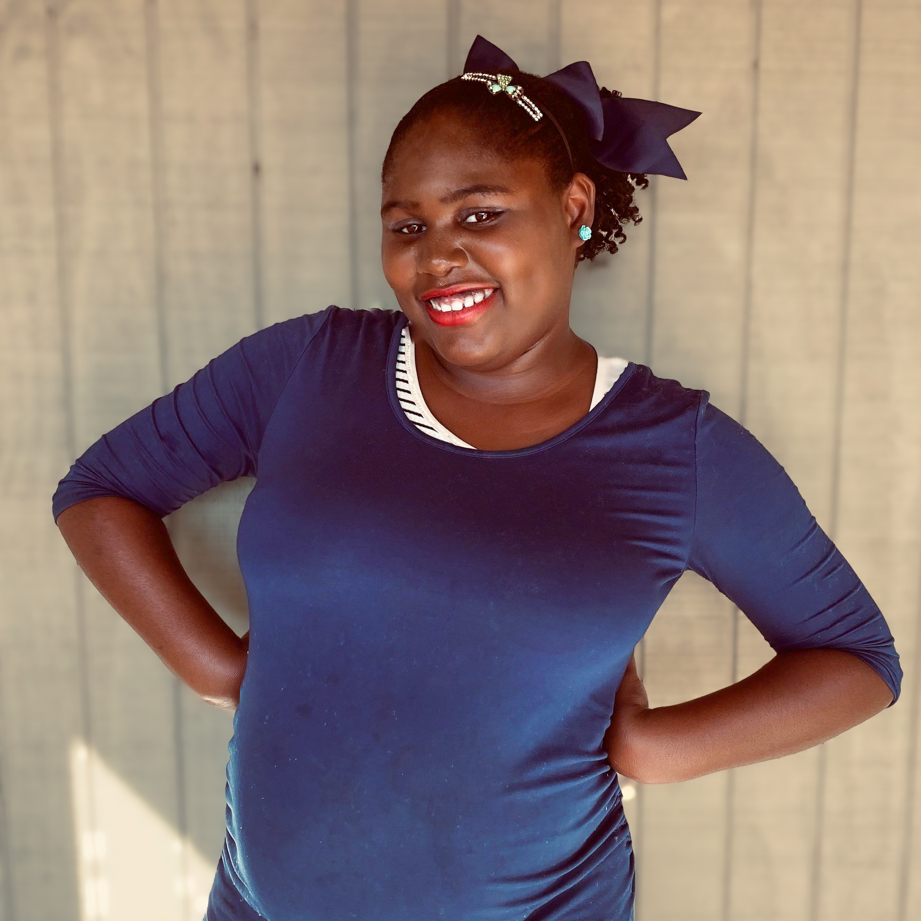 Savanna posing in front of wall