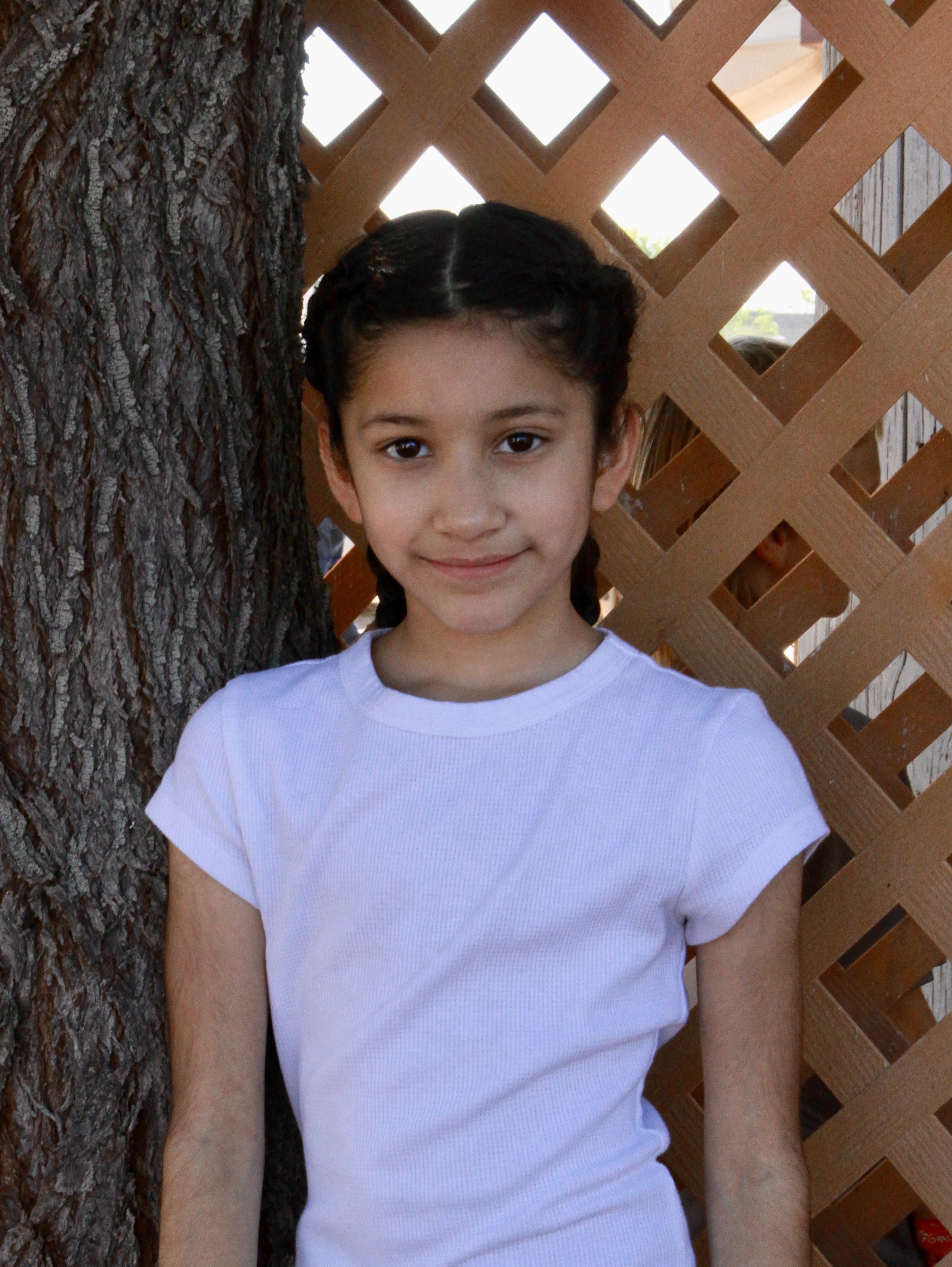 Selena standing in front of lattus