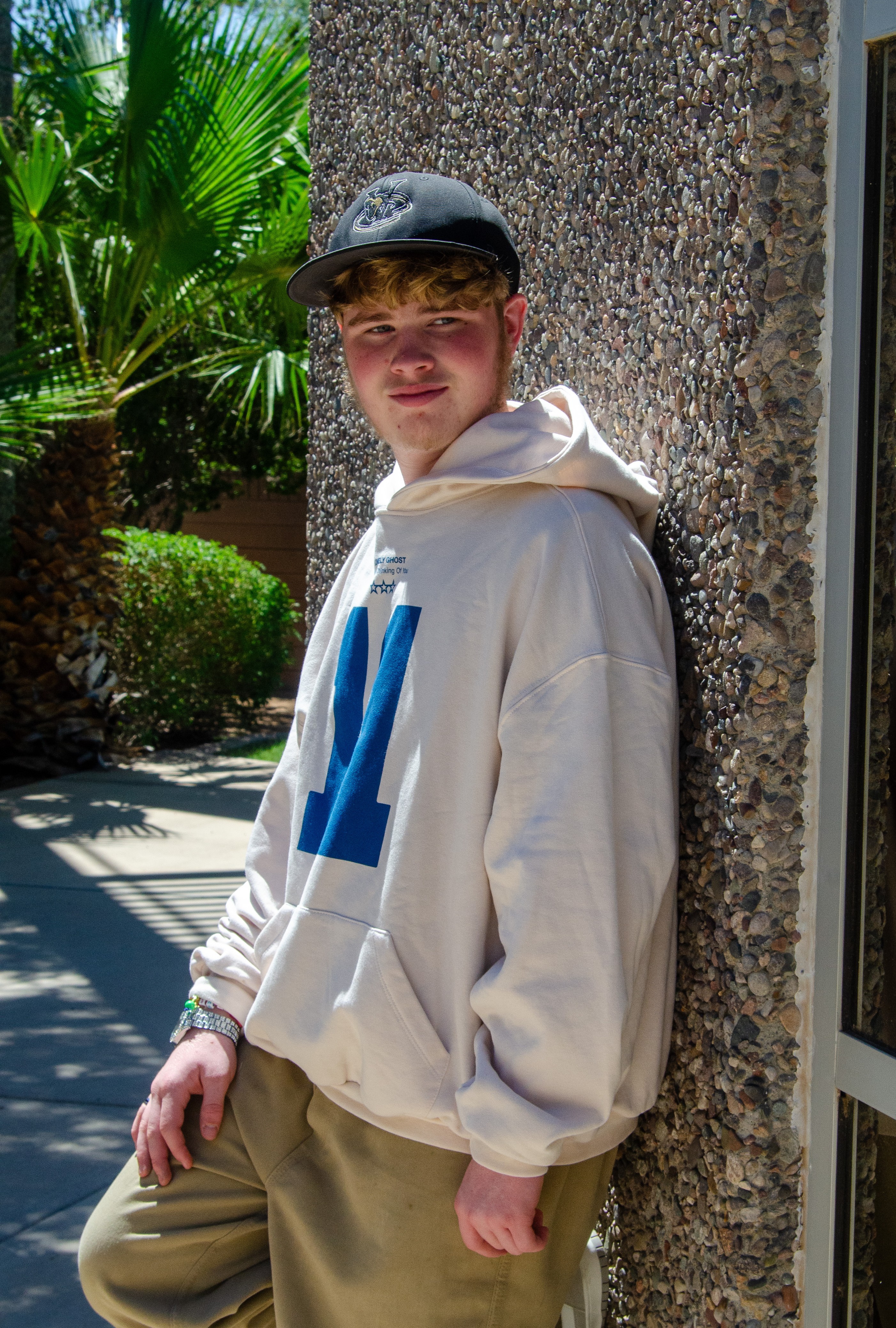 Aaron leaning against wall