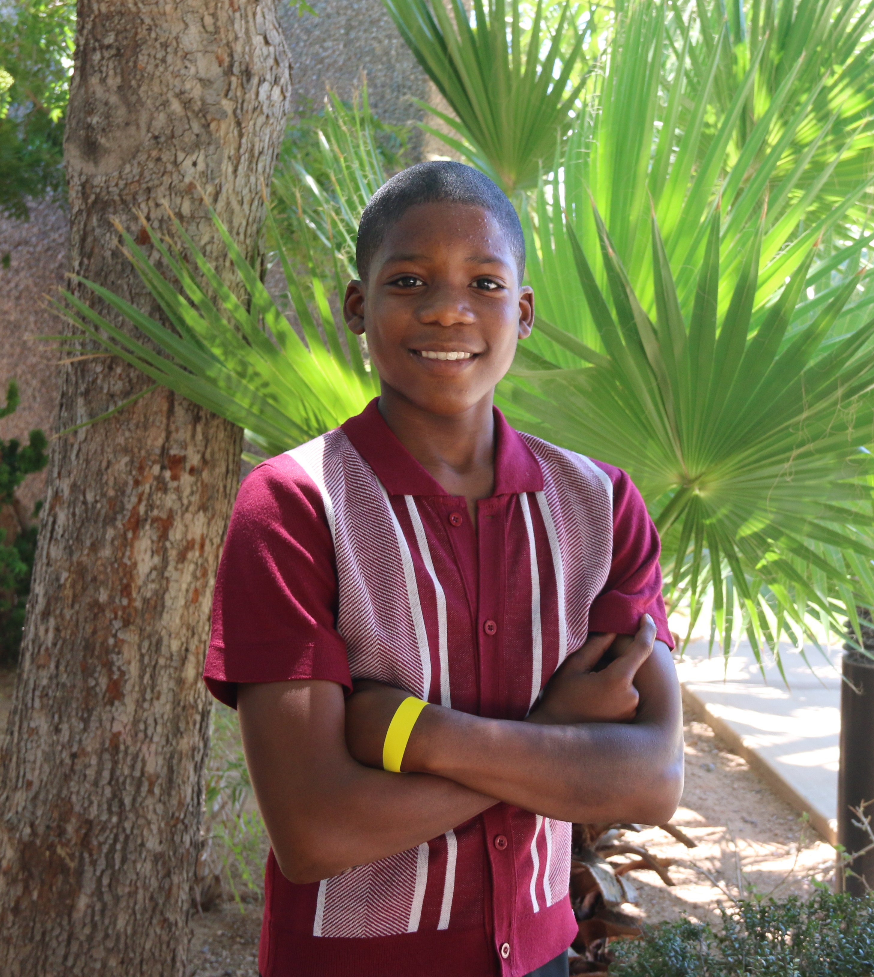Andre standing with palm tree in background