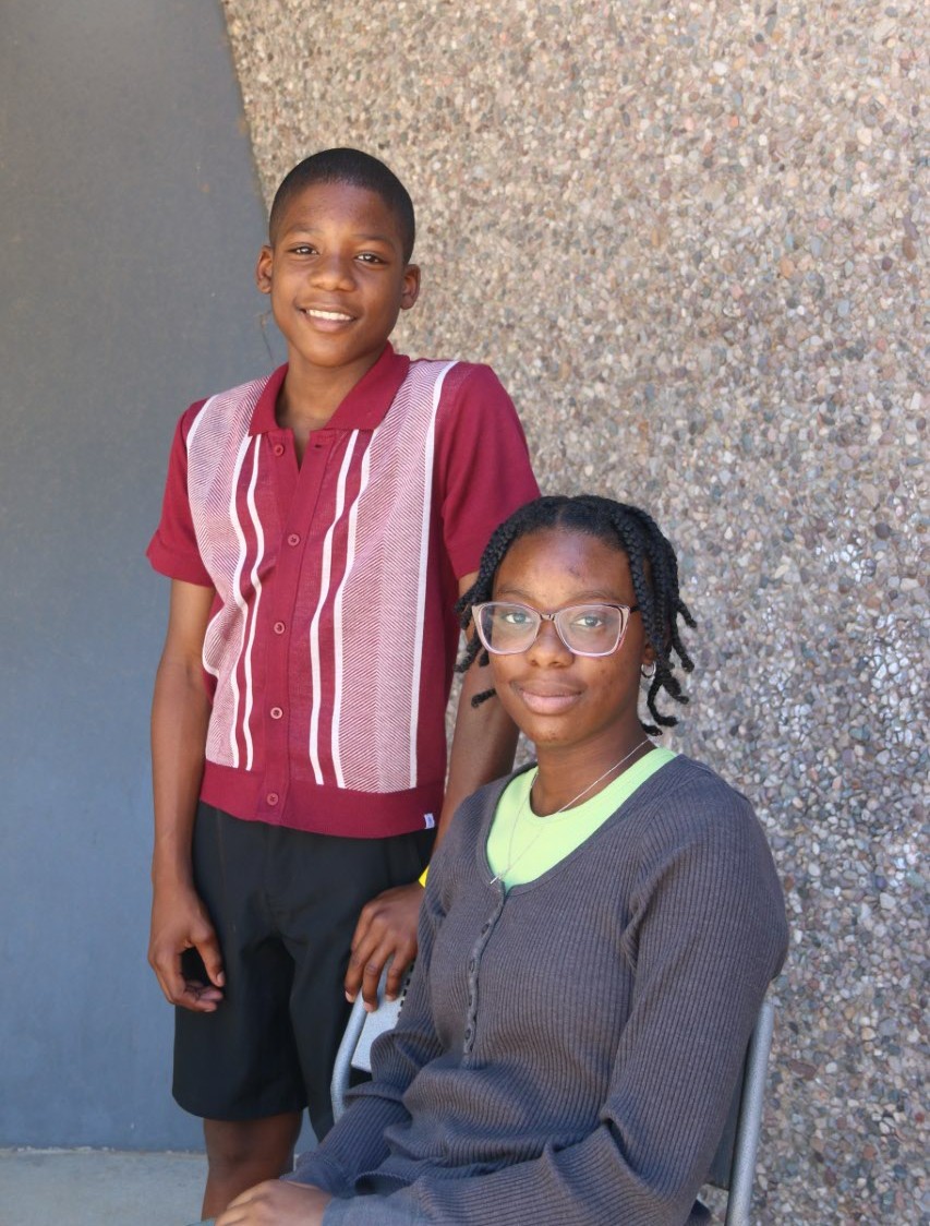 Andre standing and Aaliyah sitting