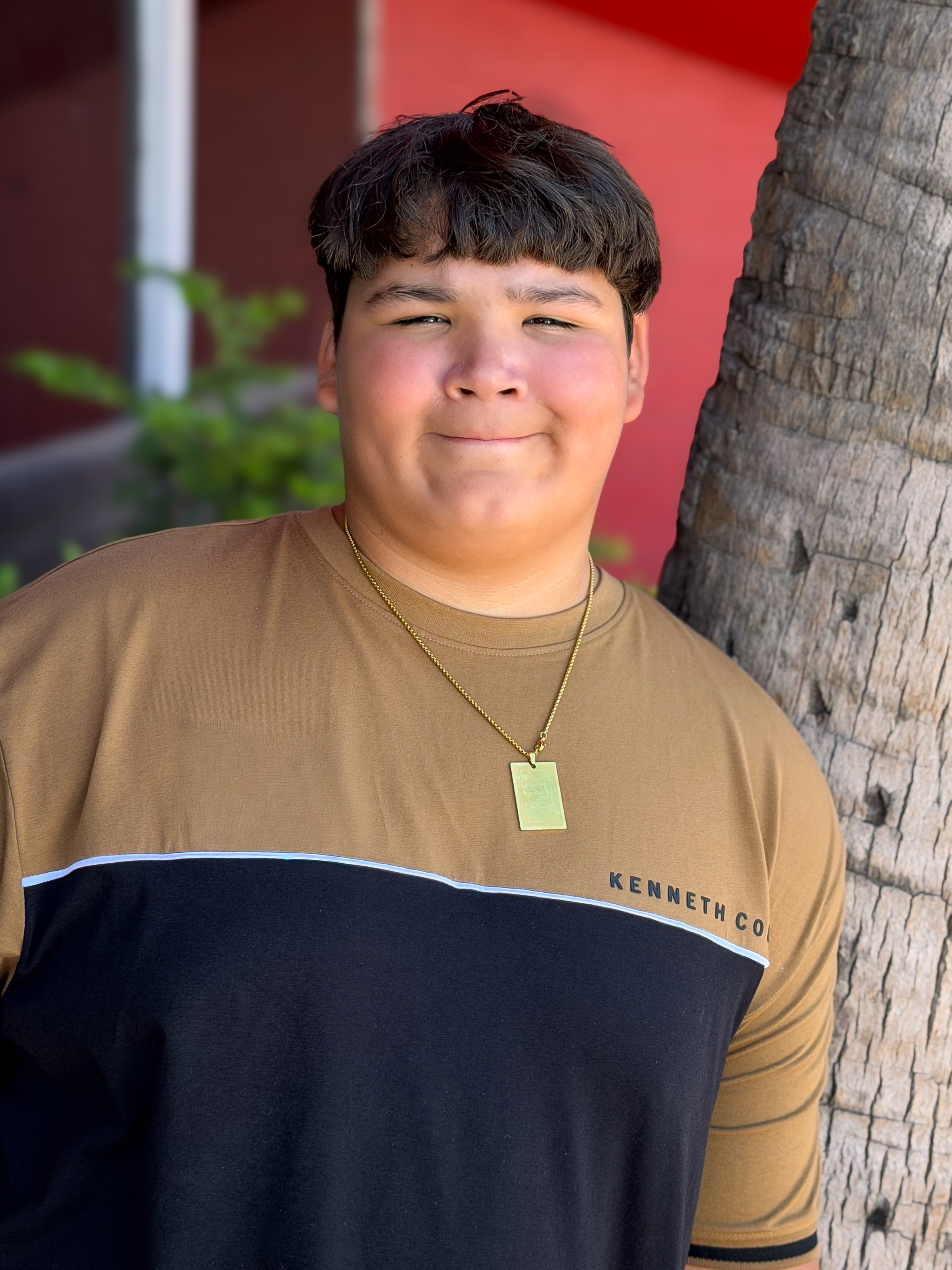 Jayden leaning on a tree