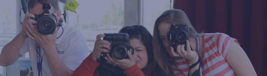 A group of people aiming their camera at the person taking their photo