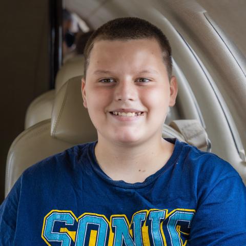 Blake sitting in jet smiling