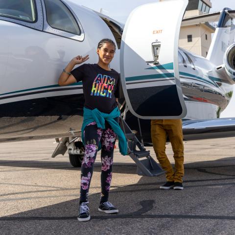 Leilani standing by plane 