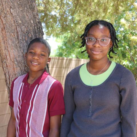 Andre and Aaliyah standing with tree in back ground